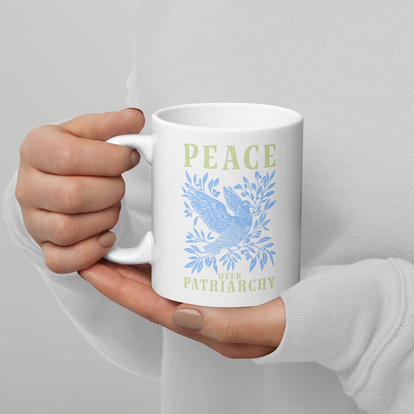 Full view of the 11 oz Peace Over Patriarchy White Mug showcasing its bold message.