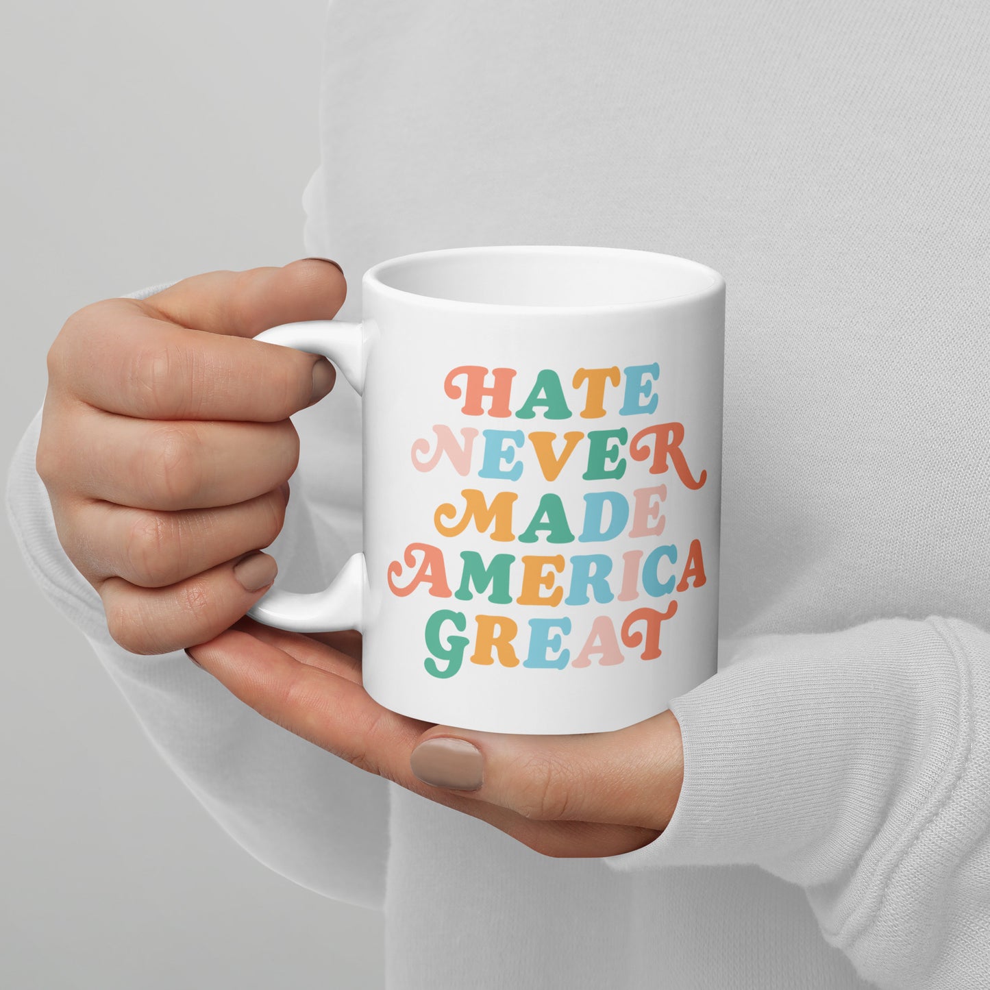 Full view of the 11 oz white mug featuring Hate Never Made America Great.