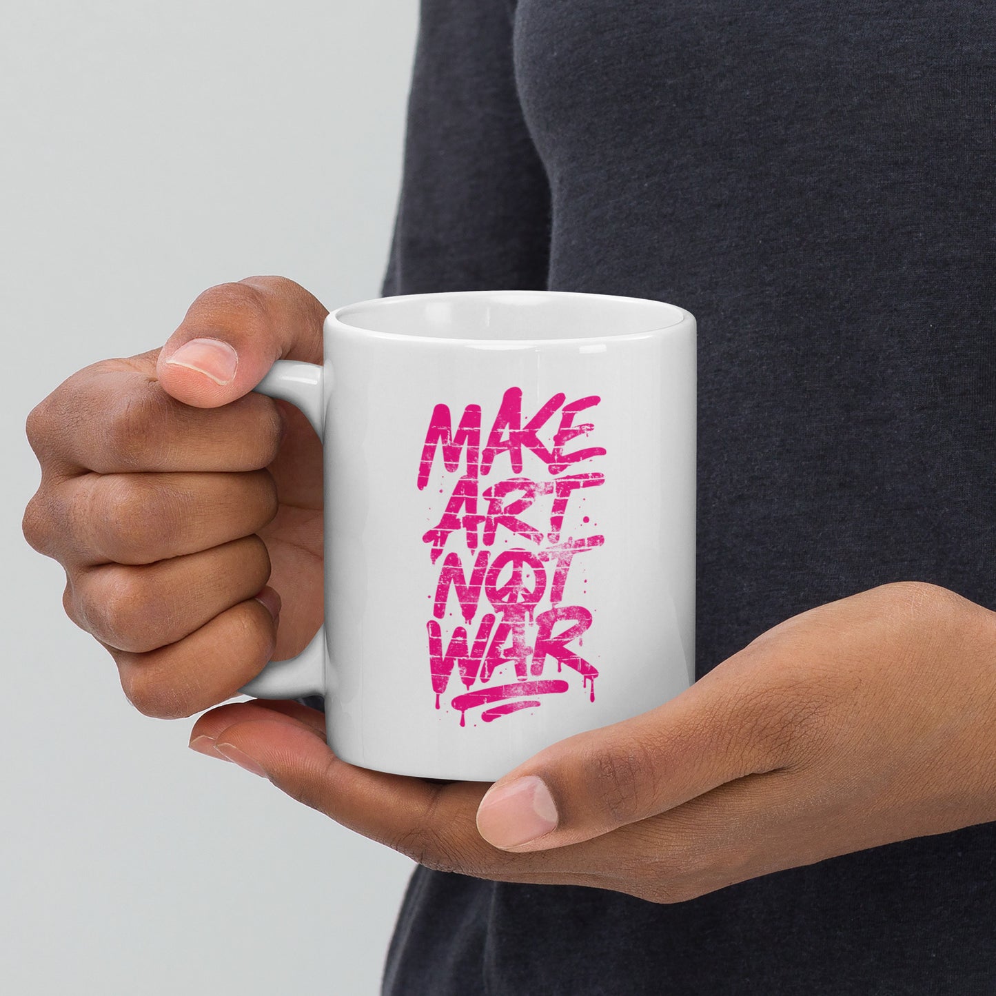 Front View Image: Front view of the 11 oz glossy mug with Make Art Not War graffiti design in pink spray-paint lettering