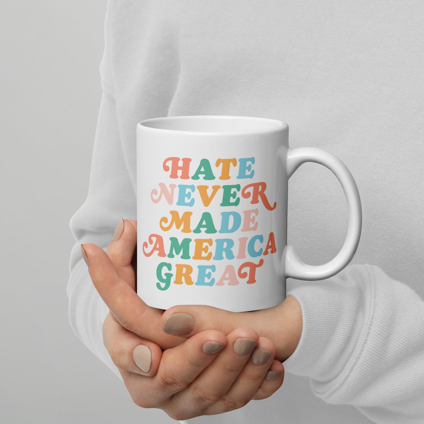 Full view of the 11 oz white mug featuring Hate Never Made America Great.