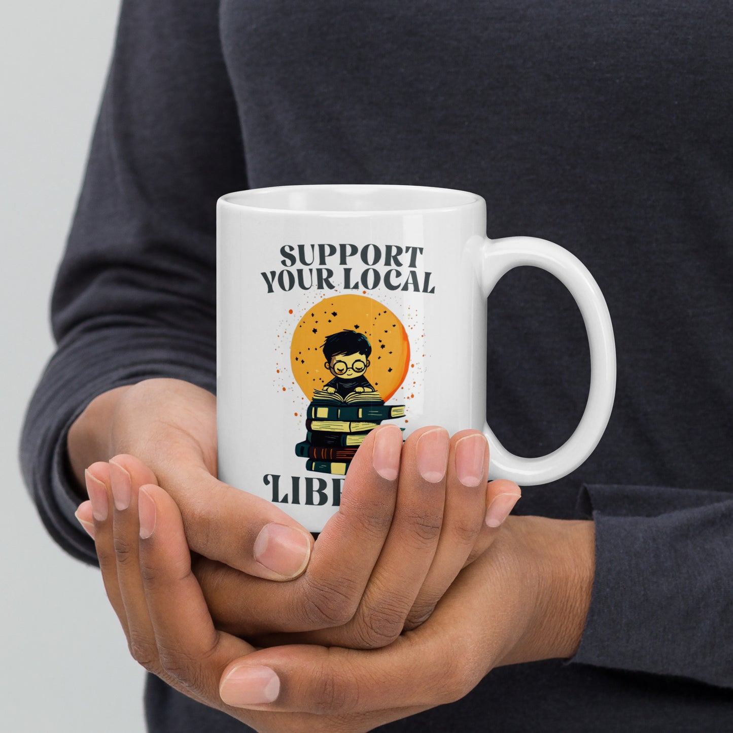 11 oz Support Your Local Library Mug held by a model.