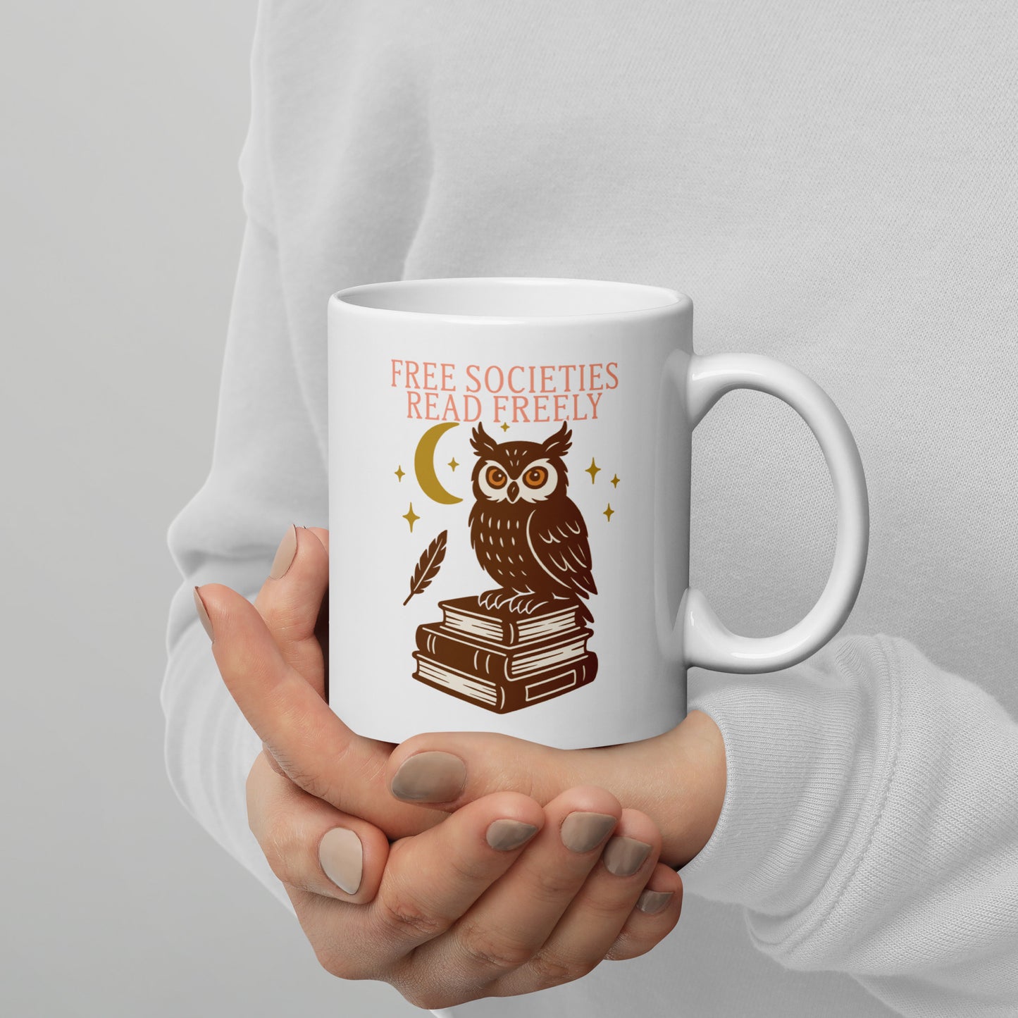 Person holding 11 oz “Free Societies Read Freely” owl graphic mug, progressive drinkware by Blue Wave USA for banned books awareness.