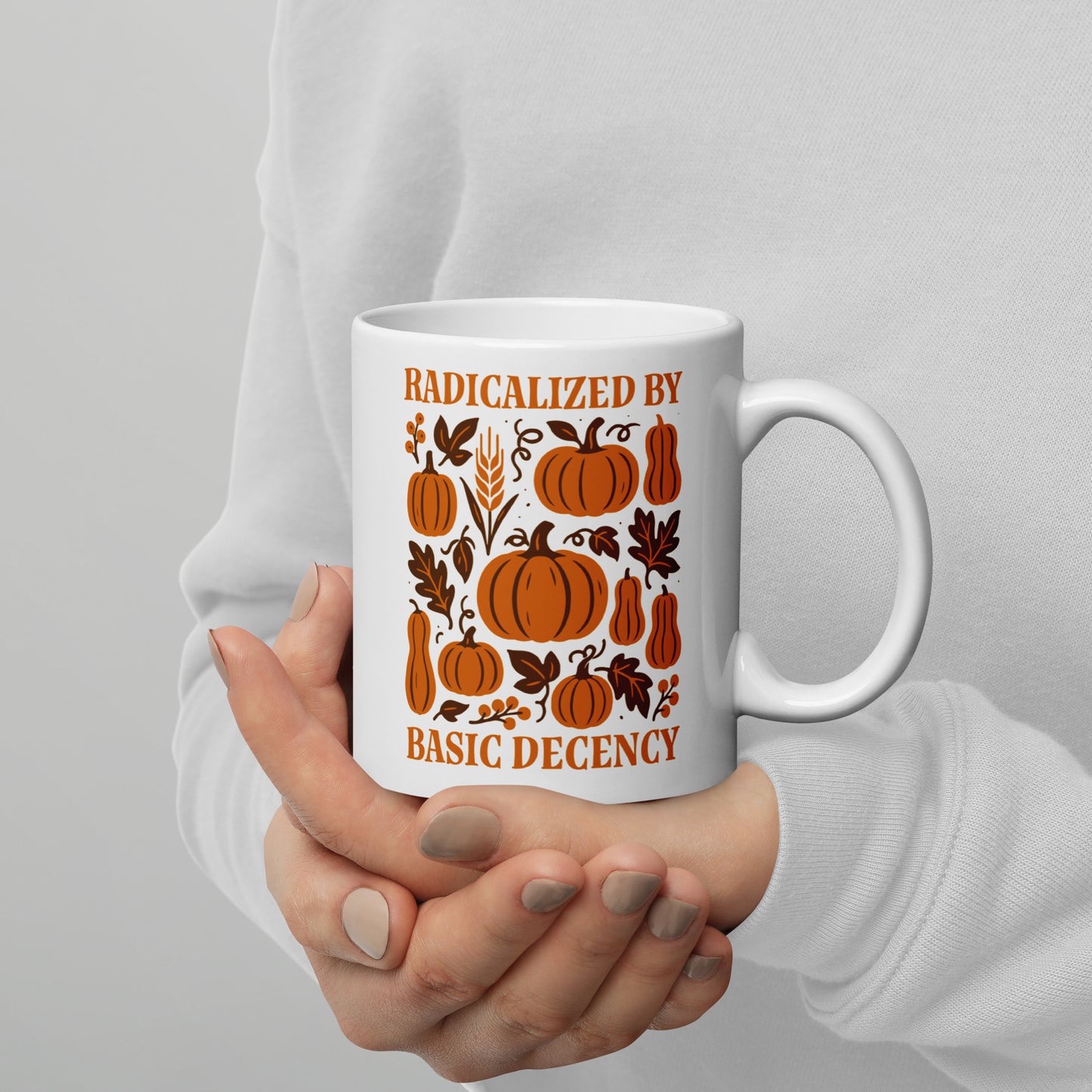 Person holding 11 oz “Radicalized by Basic Decency” Thanksgiving mug, Blue Wave USA progressive home & lifestyle drinkware.