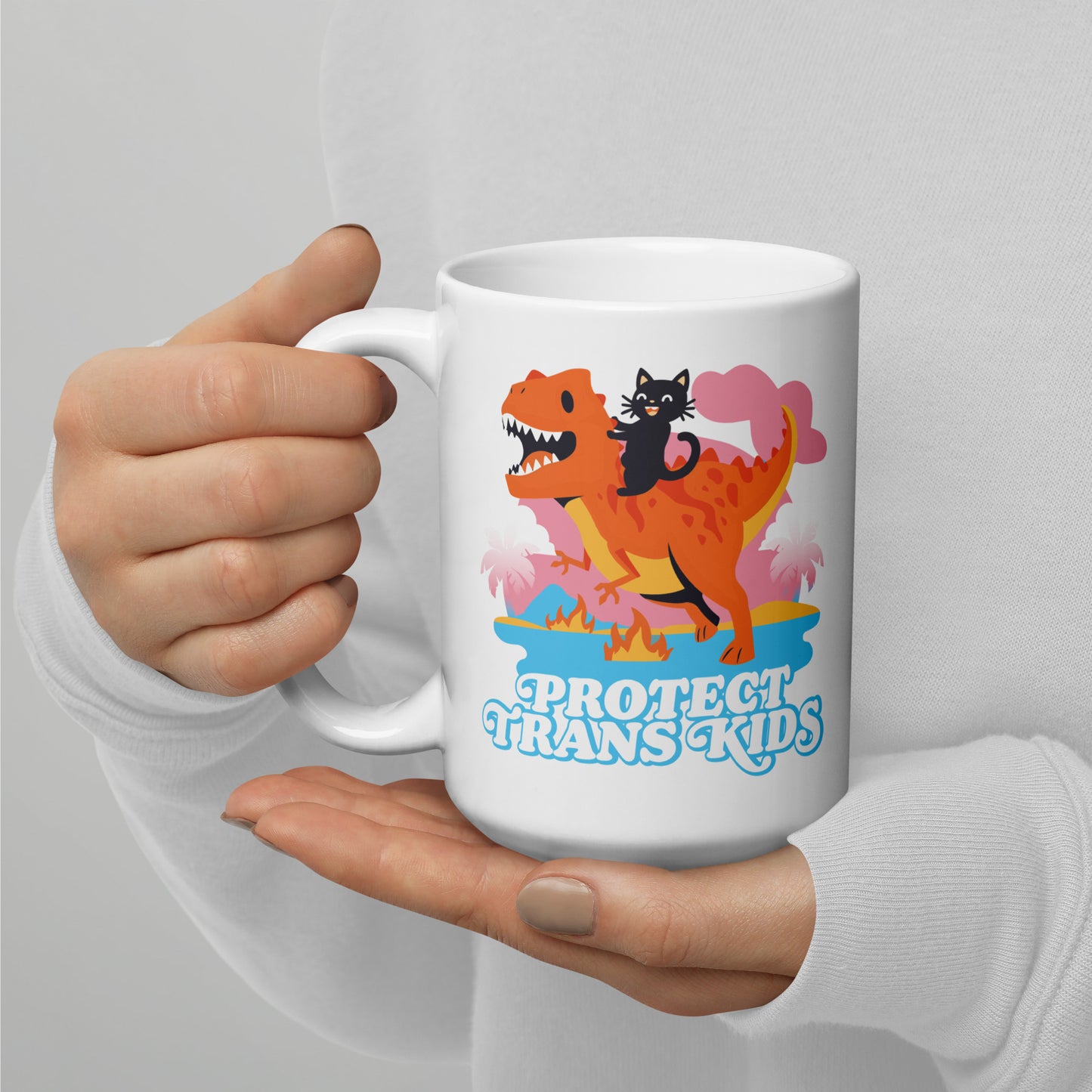 Person holding 15 oz Protect Trans Kids Mug while enjoying a hot beverage.
