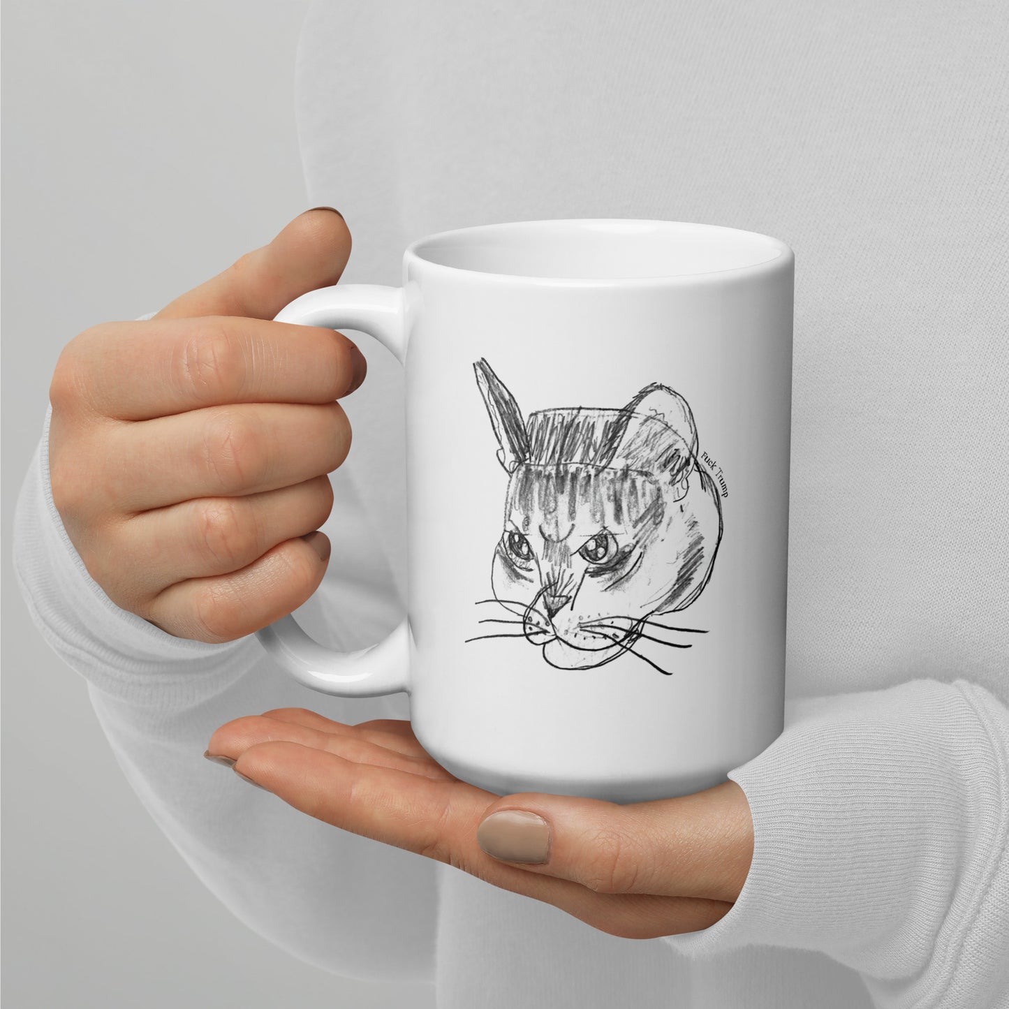 White 15 oz glossy mug featuring a funny cat illustration with a subtle anti-Trump message.