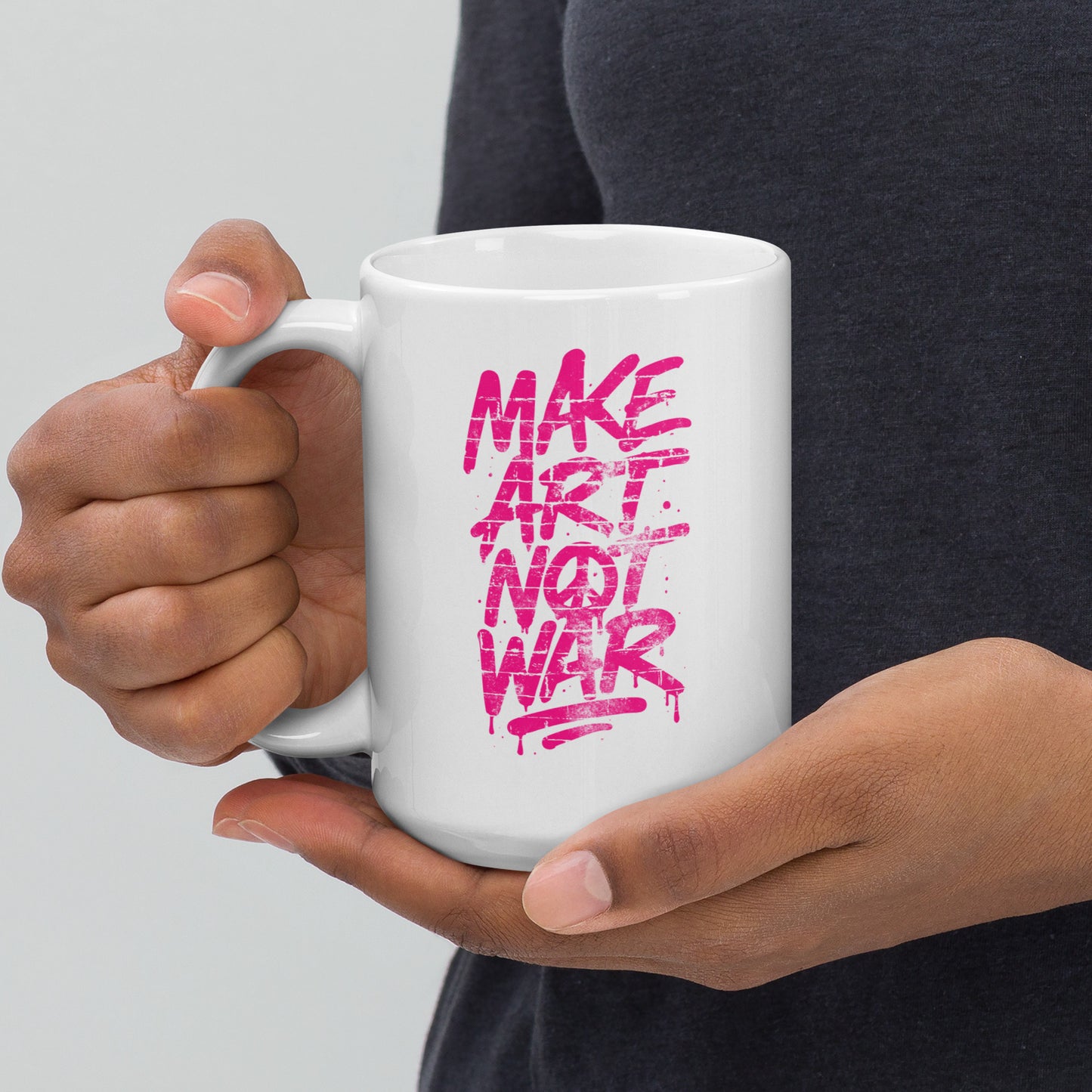 Front View Image: Front view of the 15 oz glossy mug with Make Art Not War graffiti design in pink spray-paint lettering