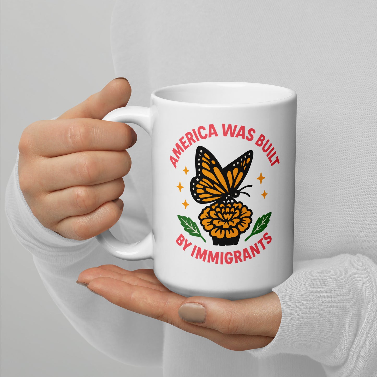 “America Was Built by Immigrants” butterfly ceramic mug with yellow flower and stars, immigrant pride coffee cup for social justice supporters.
