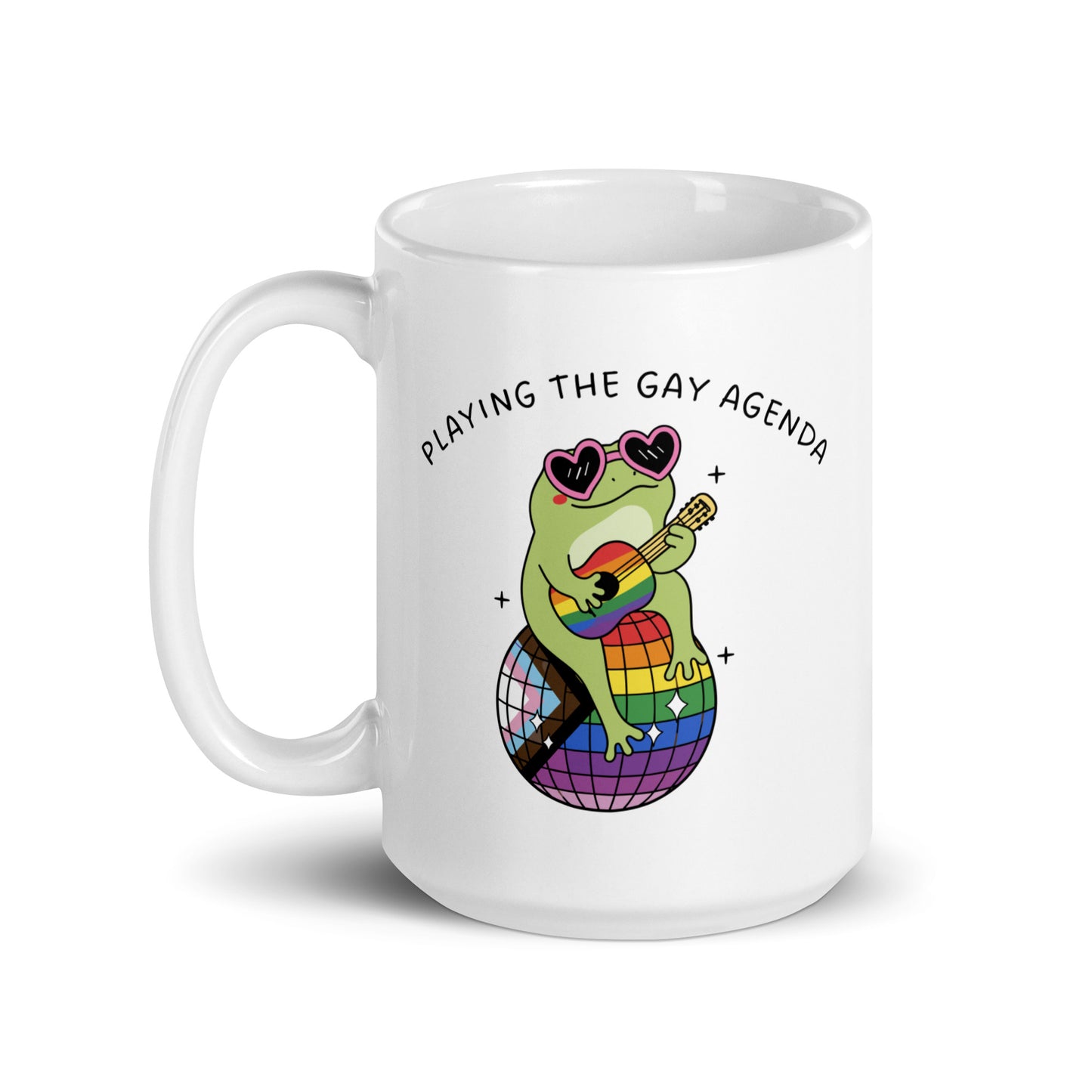 White glossy mug showcasing a retro disco frog character perched on a rainbow disco ball with playful “Playing the Gay Agenda” LGBTQ+ pride message.