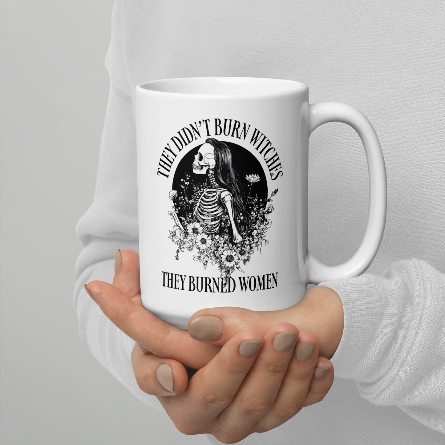 Front View Image: 15 oz white mug with “They Didn’t Burn Witches They Burned Women” text and skeleton girl design.