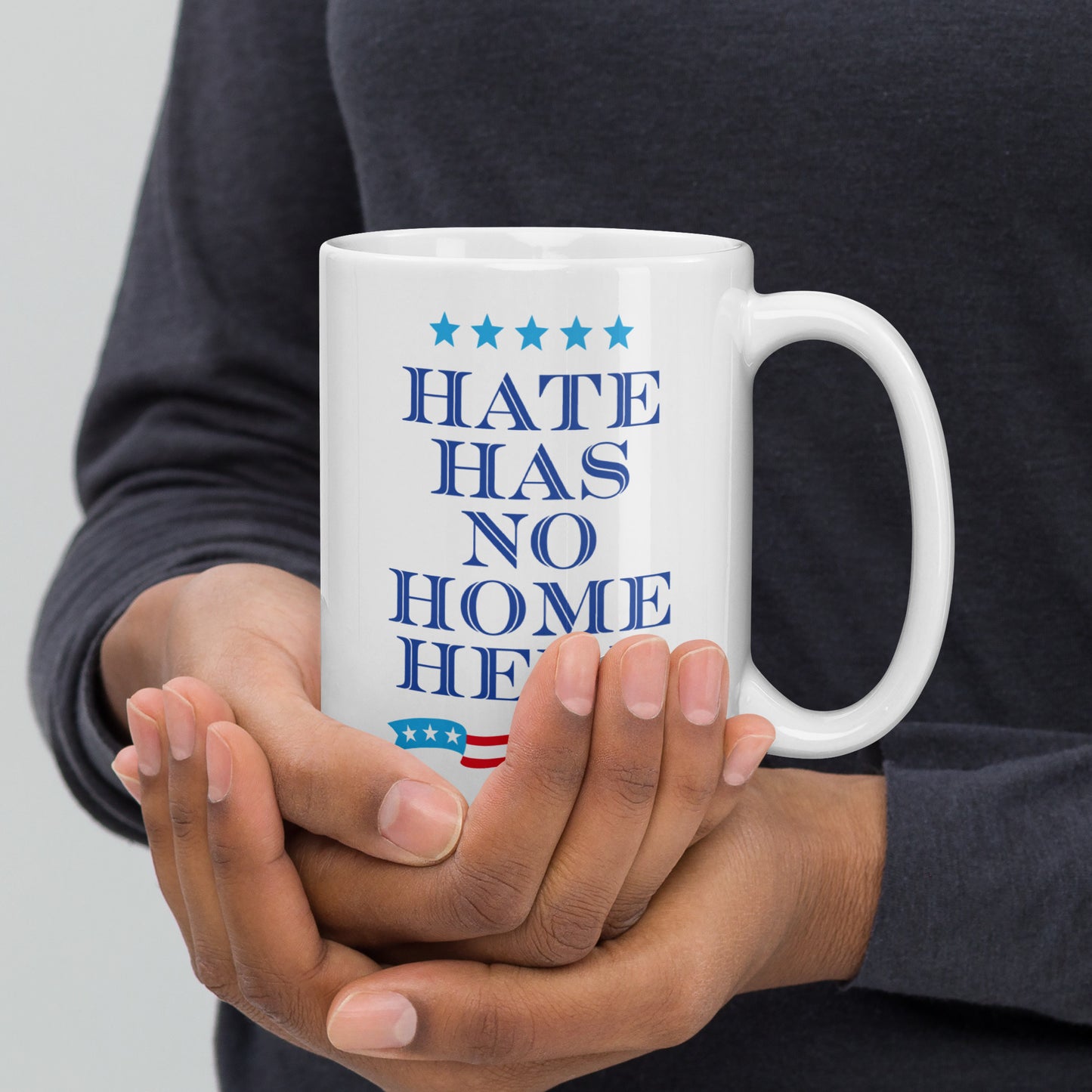 15 oz white mug featuring the Hate Has No Home Here slogan in bold text.