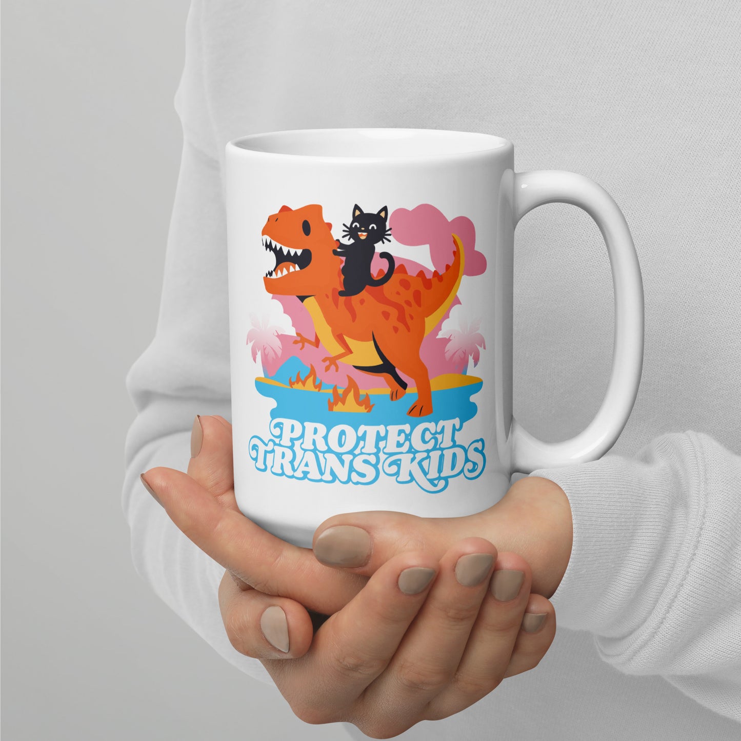 Person holding 15 oz Protect Trans Kids Mug while enjoying a hot beverage.