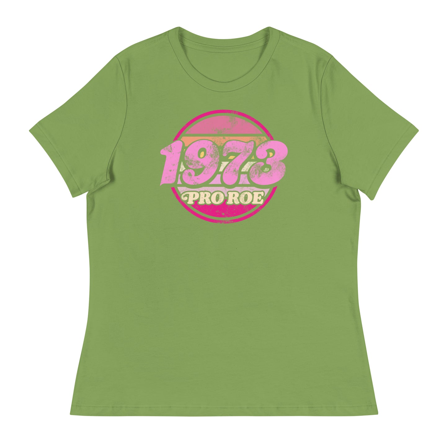 Leaf green women’s relaxed t-shirt featuring a distressed retro circular badge reading “1973 PRO ROE,” vintage reproductive freedom graphic centered on a soft pastel garment.