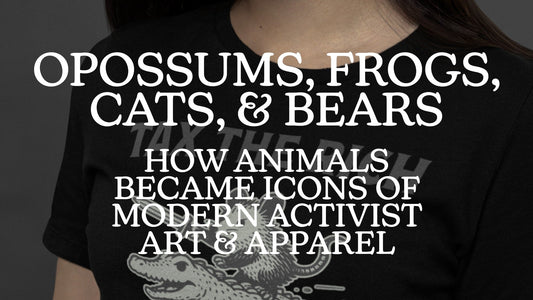 Blog header graphic for Blue Wave USA featuring the title Opossums, Frogs, Cats, and Bears over a mockup of a person wearing a Tax the Rich opossum graphic tee.
