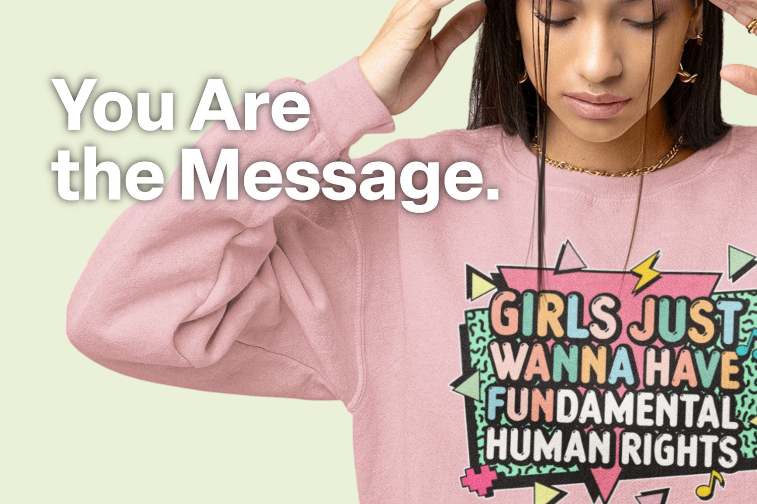 Pink sweatshirt featuring the bright, retro graphic "Girls Just Wanna Have Fundamental Human Rights."