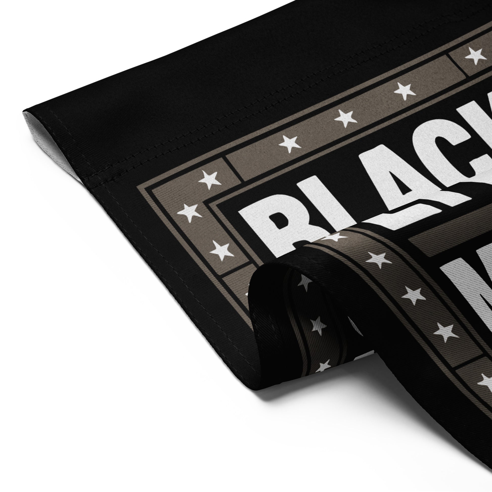 Detailed folded view of the Black Lives Matter garden flag with strong block lettering and star border.