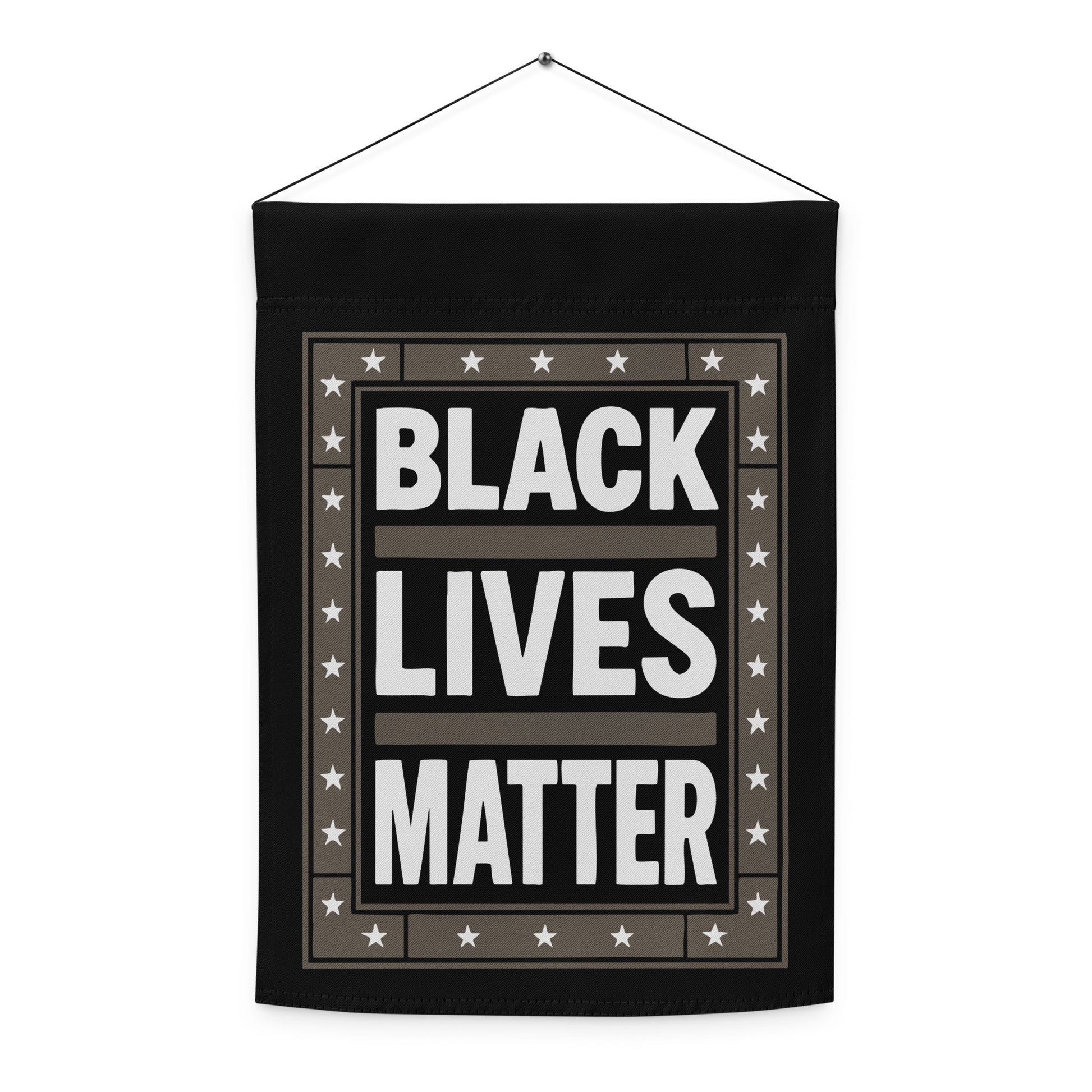 Front view of the Black Lives Matter garden flag with black background, white text, and surrounding star pattern.