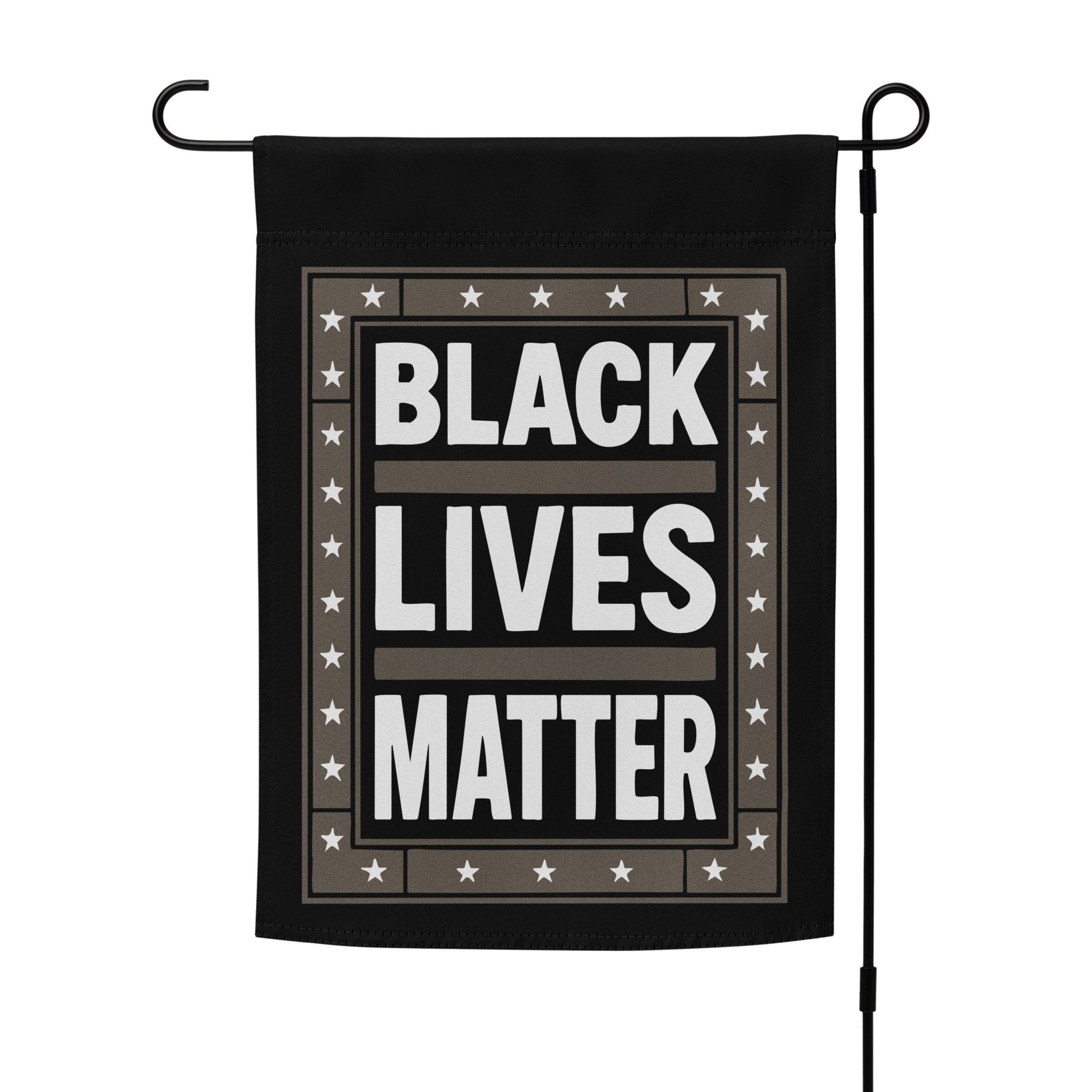 Black Lives Matter garden flag displayed on a flag stand, featuring bold white lettering and star accents.