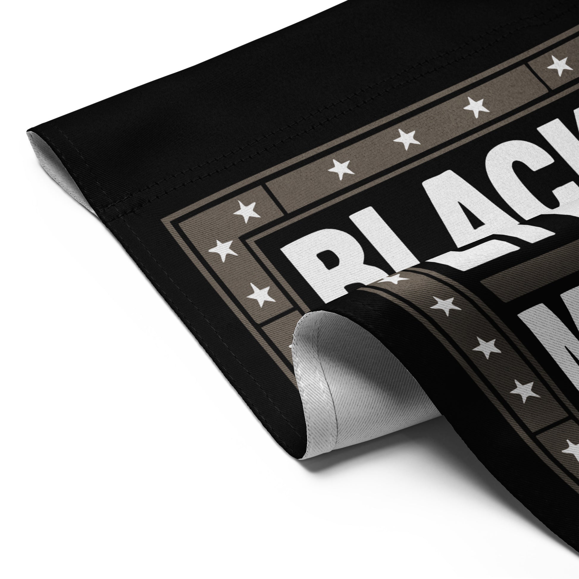 Detailed folded view of the Black Lives Matter garden flag with strong block lettering and star border.