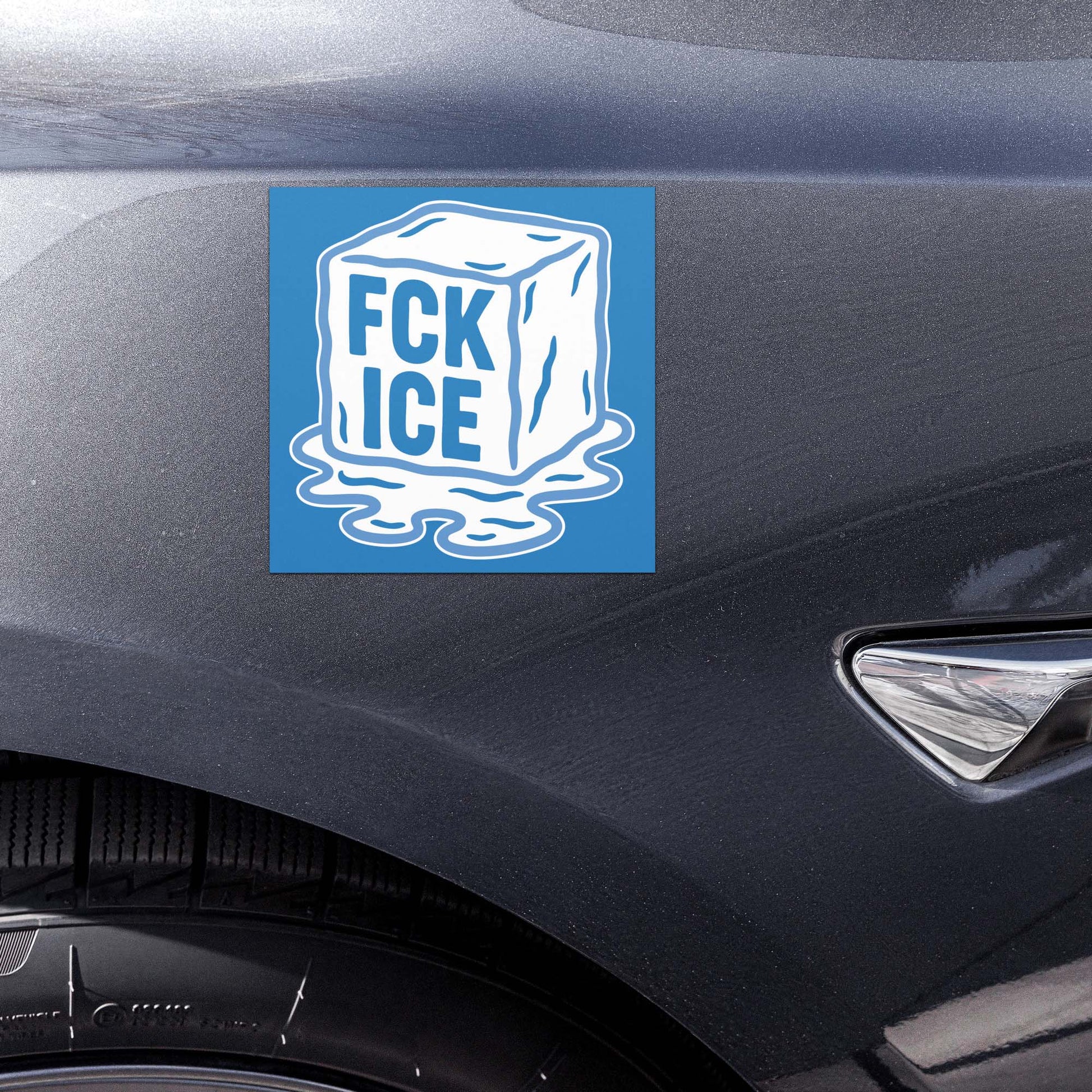 Car magnet displayed on vehicle door featuring melting ice cube illustration with bold white lettering on blue background, printed message “FCK ICE,” activist car magnet from Blue Wave USA.