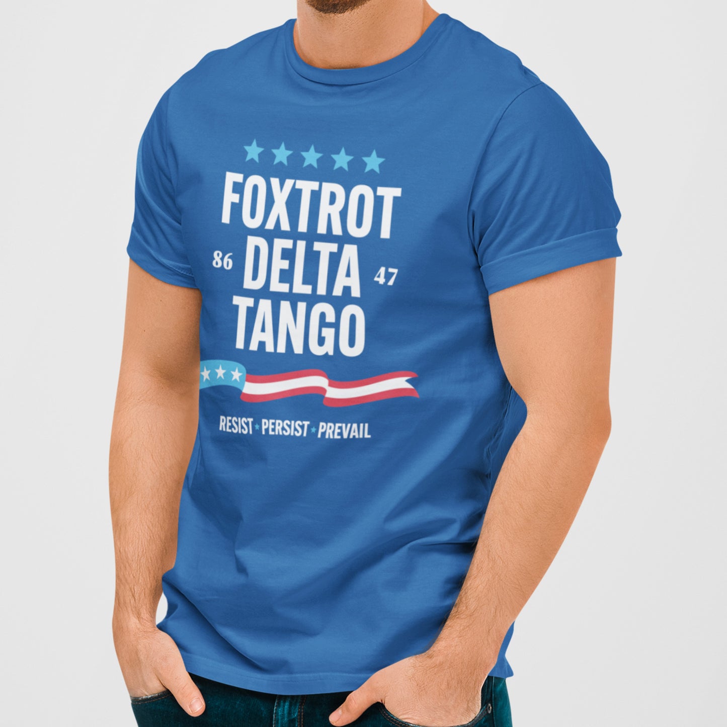 Model wearing royal blue unisex t-shirt featuring “FOXTROT DELTA TANGO” text with five stars, numbers “86” and “47,” patriotic stripe graphic, and “RESIST • PERSIST • PREVAIL.” slogan.