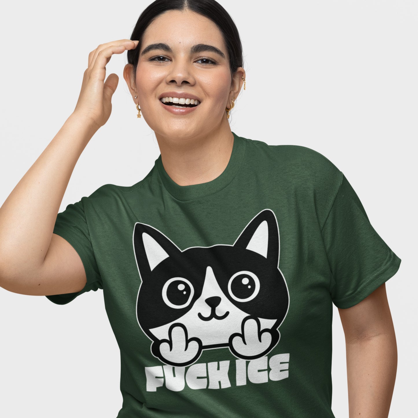Model wearing forest green t-shirt featuring bold graphic cartoon cat with raised middle finger, clean white line art, centered print, message “FUCK ICE,” progressive graphic t-shirt from Blue Wave USA.
