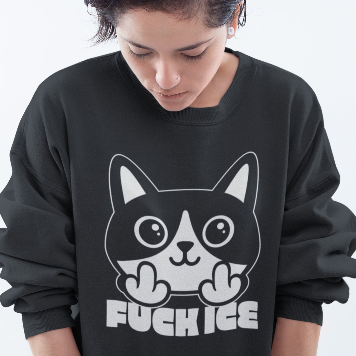 Model wearing black unisex premium sweatshirt with bold graphic cat illustration giving the middle finger, high-contrast white print, centered design, printed message “FUCK ICE.”