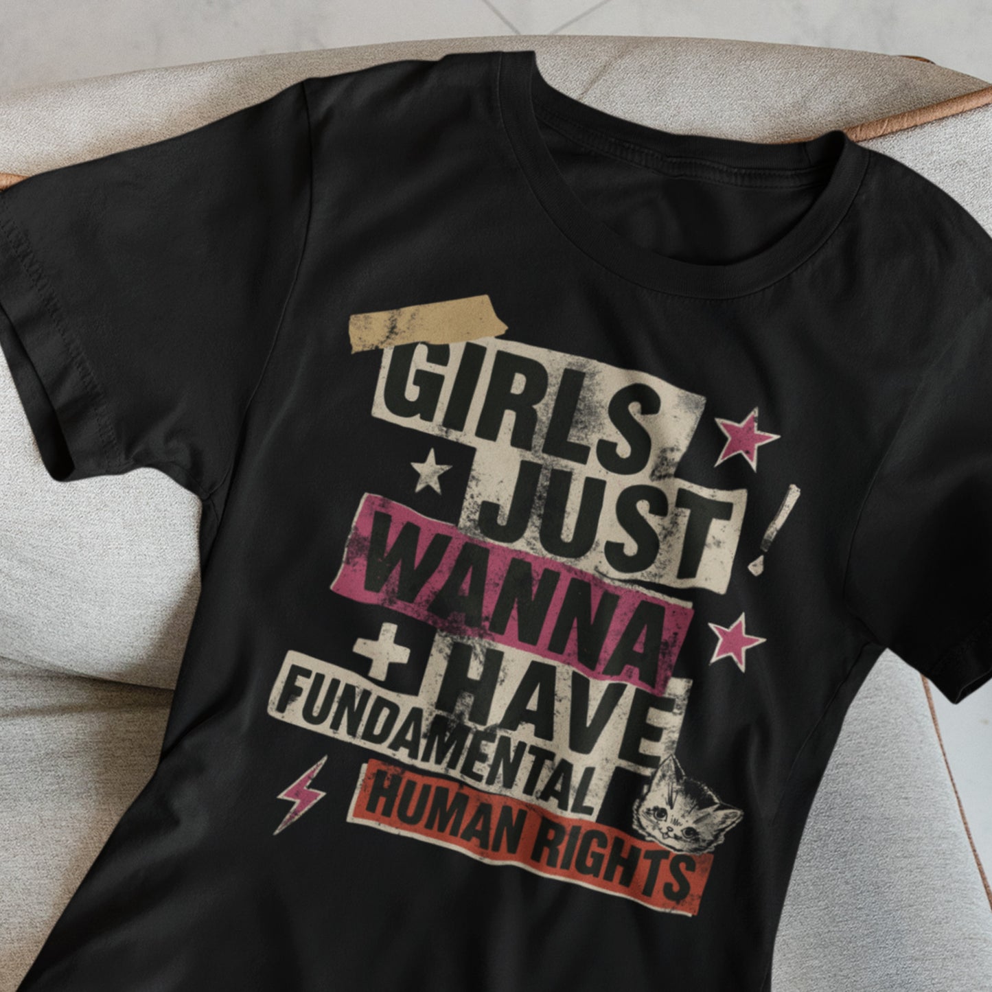 Flat lay black punk collage feminist tee with distressed lettering and lightning graphics. A stylish, rebellious everyday activism shirt.