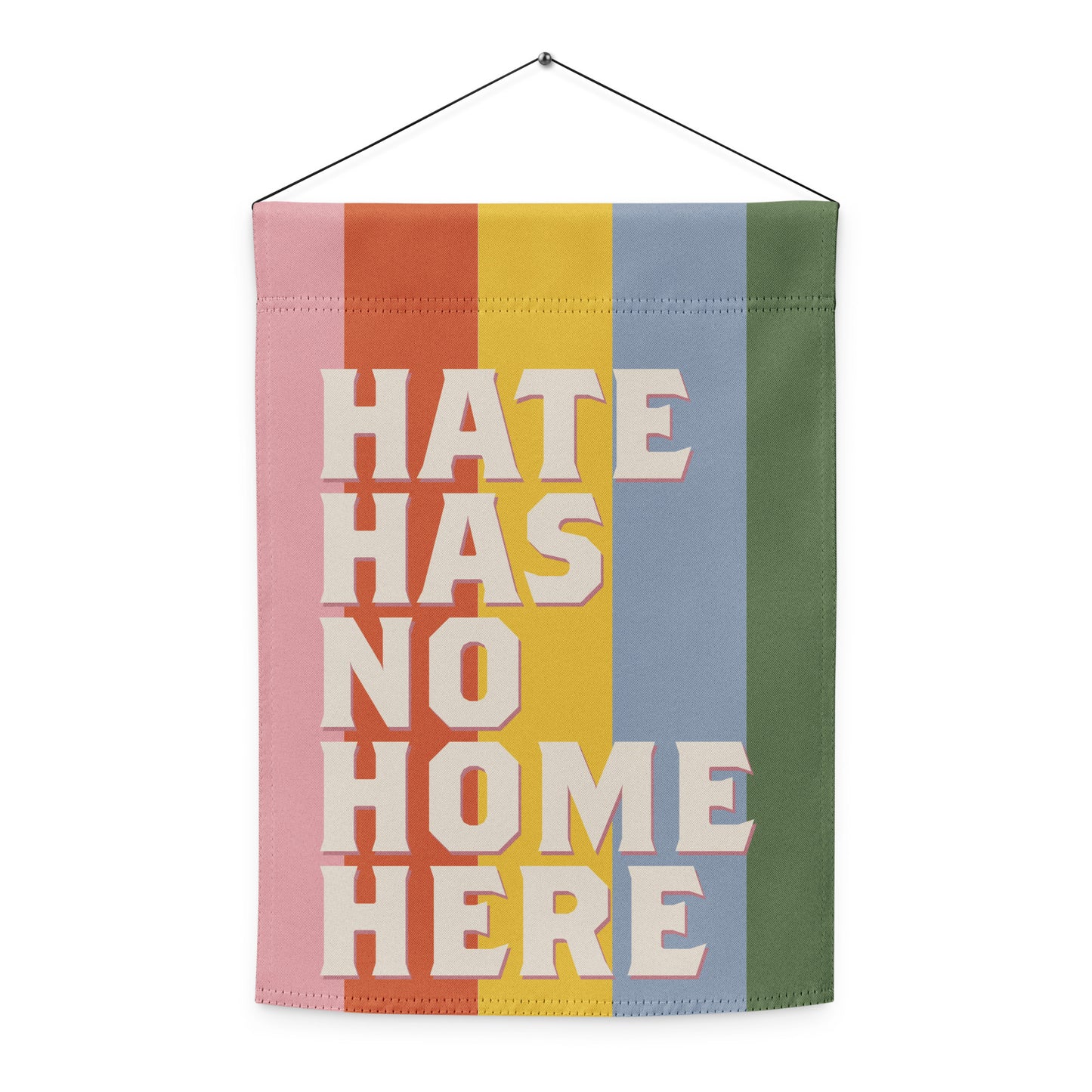 Progressive garden flag hanging vertically on wall mount featuring retro stacked typography and rainbow stripe design, inclusive home decor from Blue Wave USA.