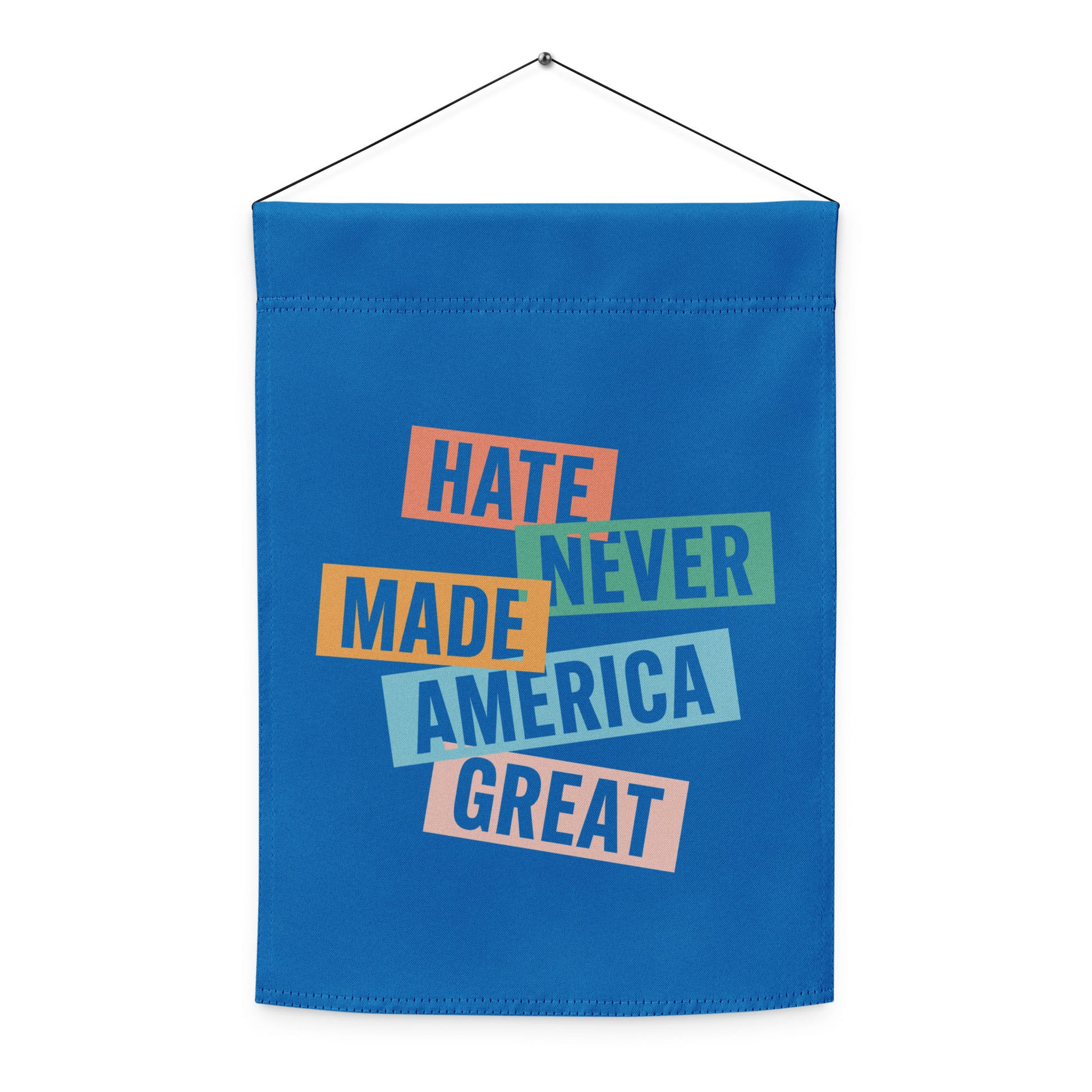 Blue progressive garden flag hanging on wall mount featuring stacked typography artwork, centered composition, activist home and garden decor from Blue Wave USA.