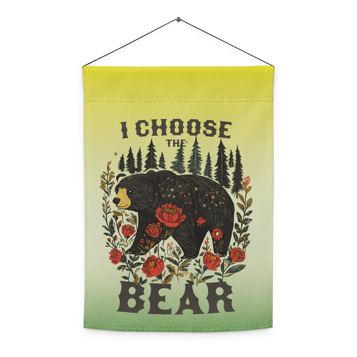 Indoor hanging view of the light green garden flag, showcasing the full folk-art illustration of a bear framed by flowers and trees with text reading “I CHOOSE THE BEAR,” from Blue Wave USA.