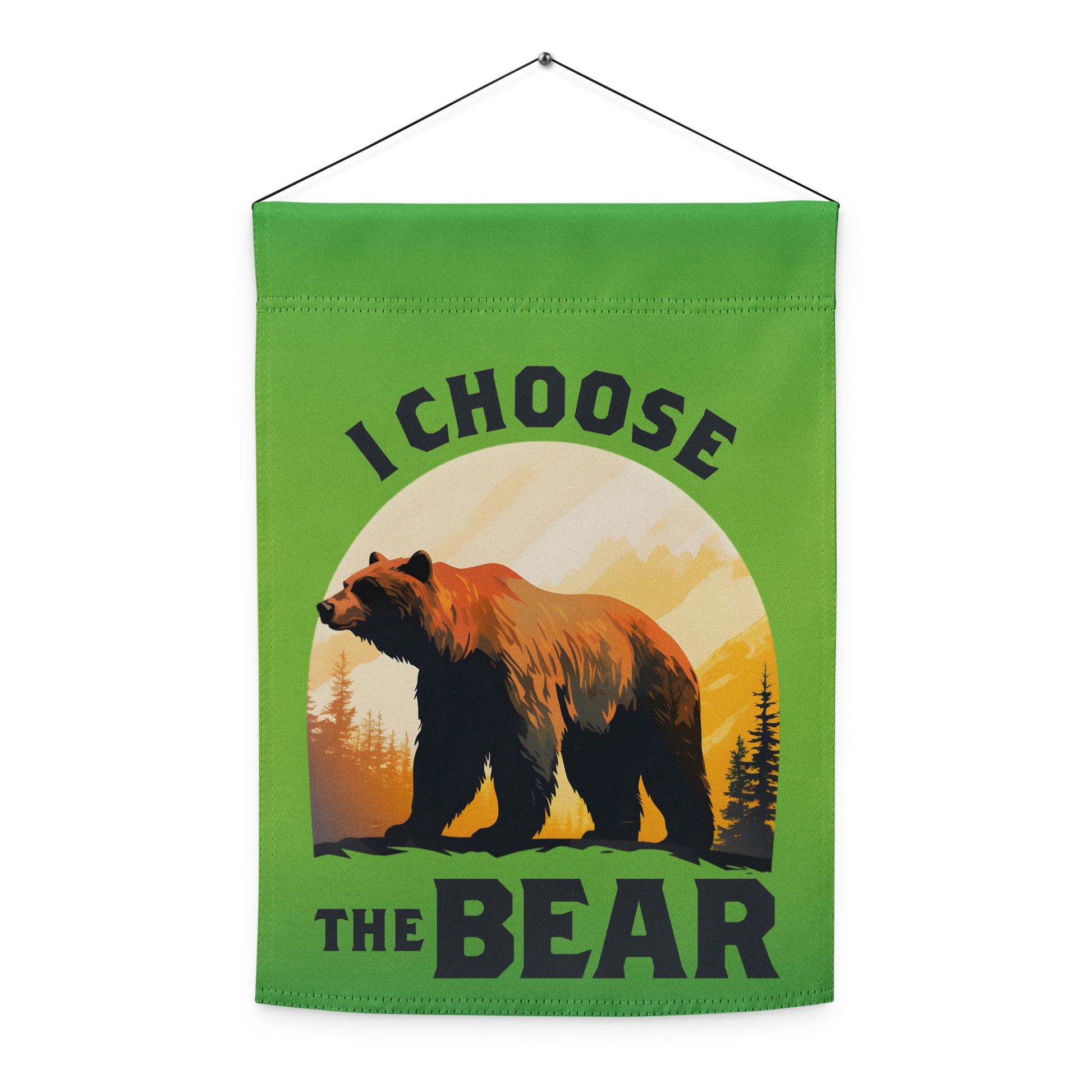 Indoor hanging view of the garden flag, showcasing the full sunset-style bear artwork with forest details and bold lettering reading “I CHOOSE THE BEAR,” from Blue Wave USA.