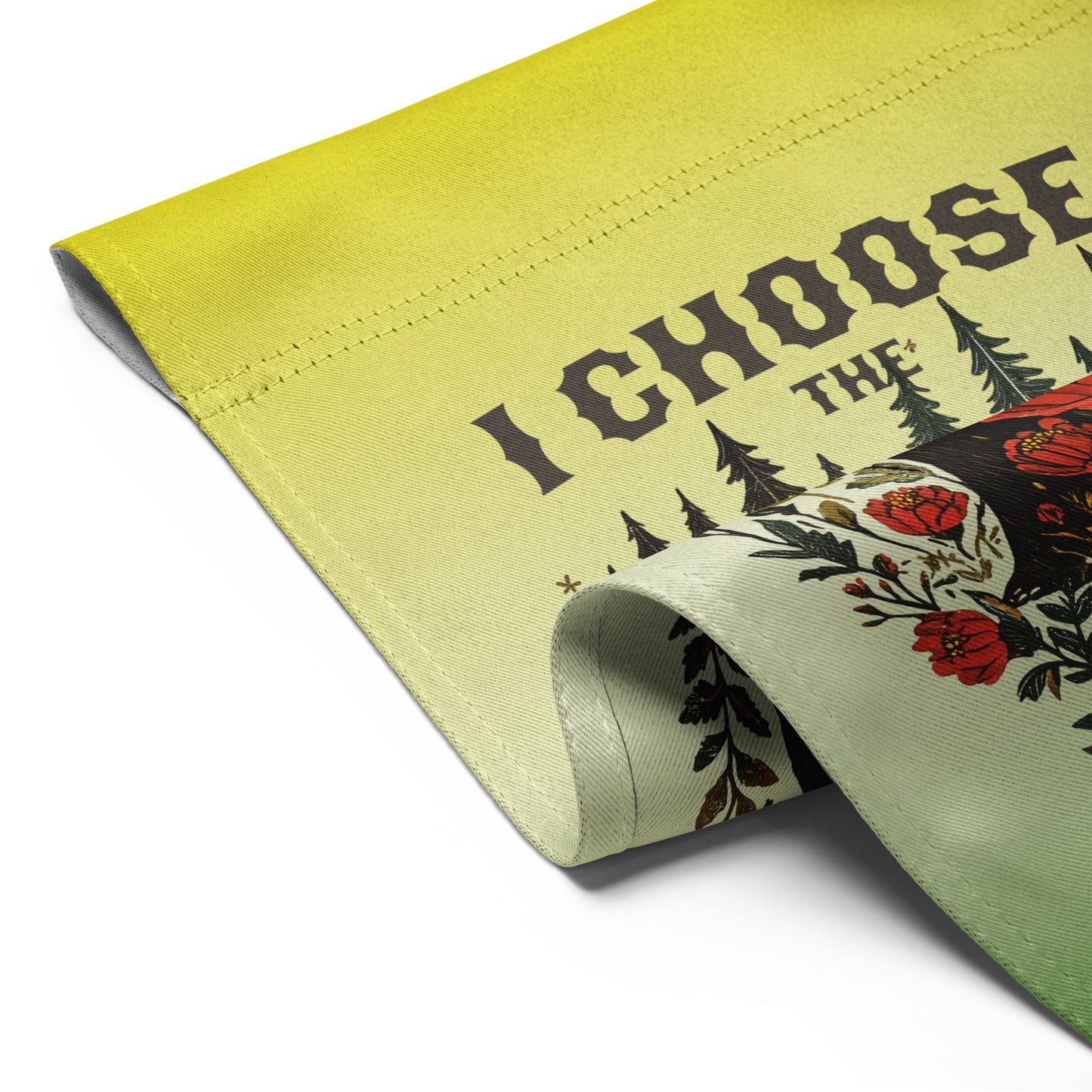 Folded light green garden flag shown flat, revealing the folk-art bear illustration, floral details, and bold lettering reading “I CHOOSE THE BEAR.”