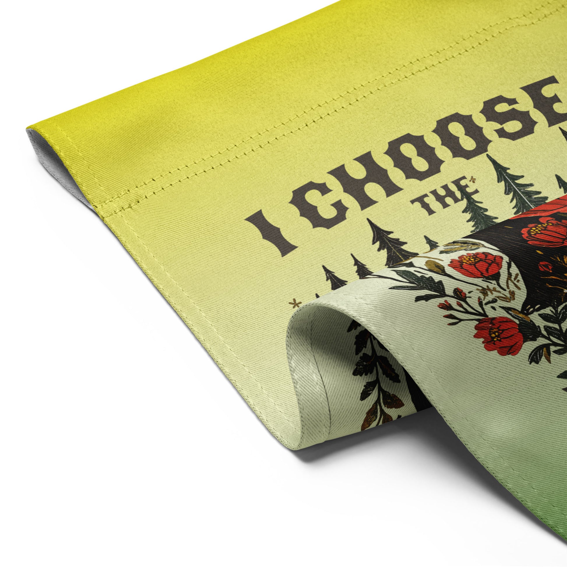 Folded light green garden flag shown flat, revealing the folk-art bear illustration, floral details, and bold lettering reading “I CHOOSE THE BEAR.”