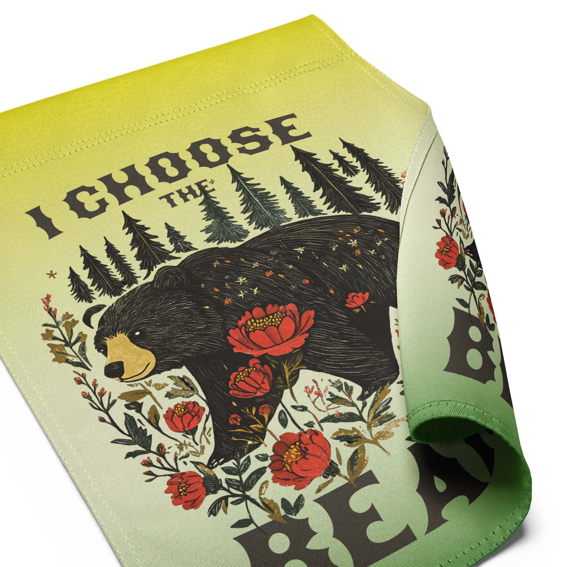 Close-up of the garden flag fabric showing stitched edges, smooth texture, and partial view of the illustrated bear and floral design with the phrase “I CHOOSE THE BEAR.”