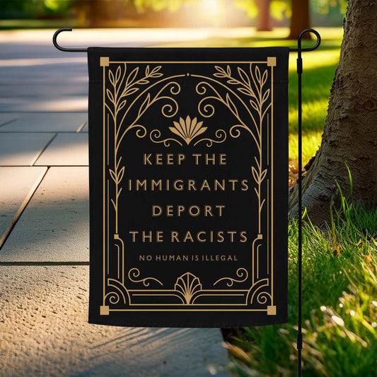 Keep The Immigrants Deport The Racists Garden Flag displayed on a stand outdoors.