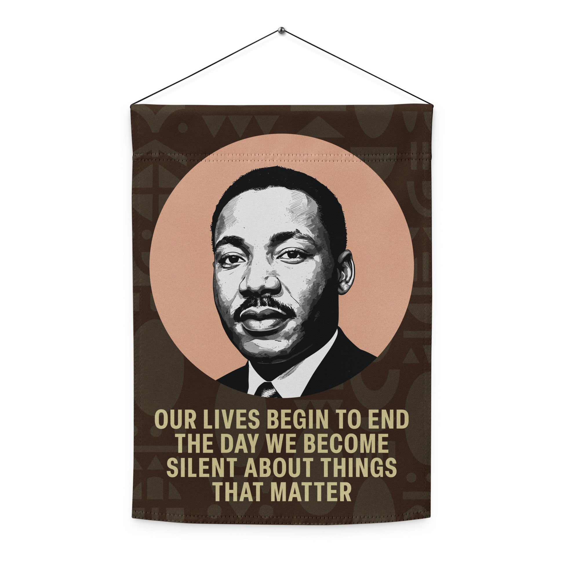 A hanging wall-style version of the garden flag printed with MLK’s portrait and the quote “OUR LIVES BEGIN TO END THE DAY WE BECOME SILENT ABOUT THINGS THAT MATTER,” shown indoors. Blue Wave USA product.