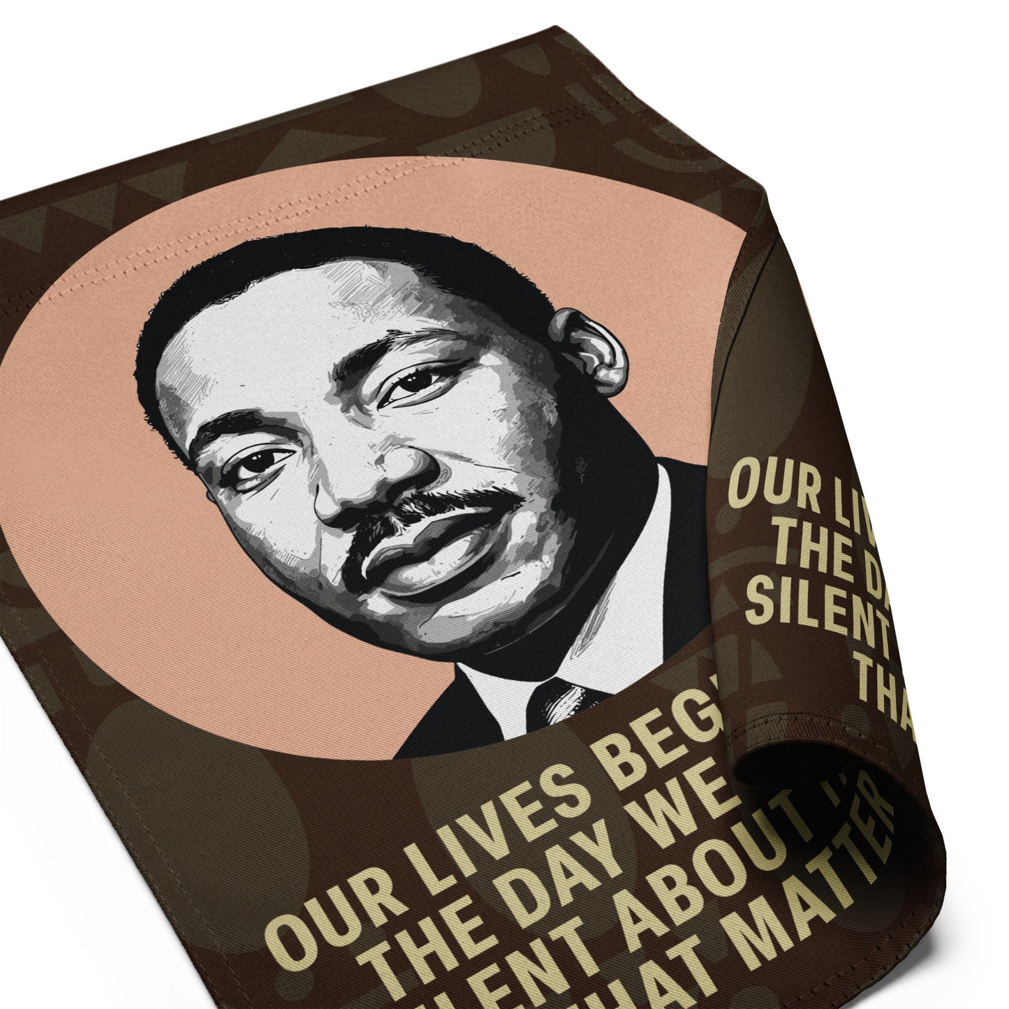Close-up view of the garden flag fabric showing Martin Luther King Jr.’s portrait and part of the quote “OUR LIVES BEGIN TO END THE DAY WE BECOME SILENT ABOUT THINGS THAT MATTER,” highlighting print quality and texture.