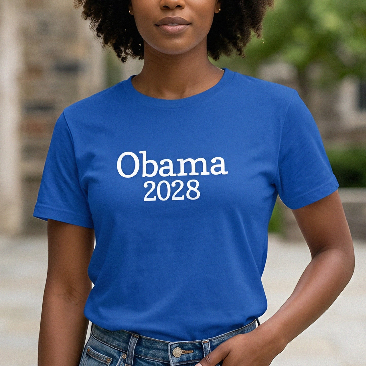 Model wearing blue unisex classic tee featuring clean white text reading “Obama 2028” in simple centered typography.