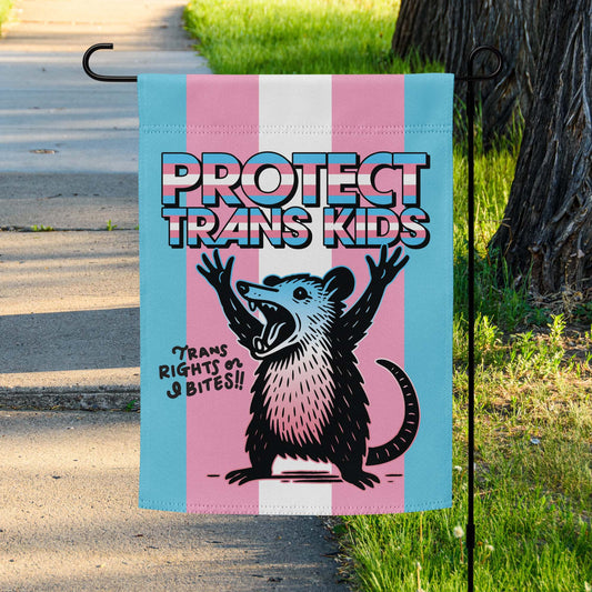 Protect Trans Kids Progressive Garden Flag with opposum displayed outside