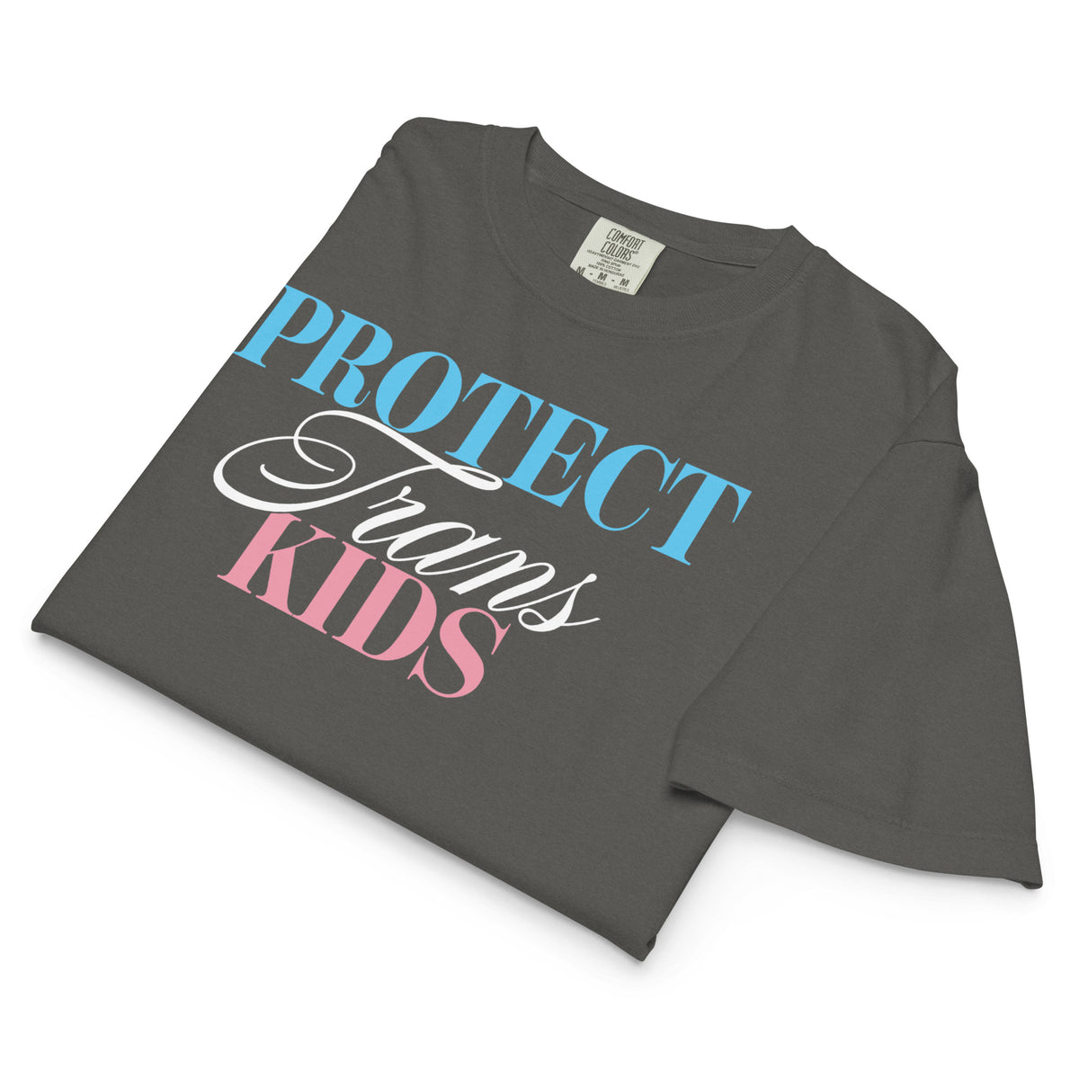 Folded pepper women’s boxy tee showcasing the “Protect Trans Kids” design and the shirt’s relaxed, heavyweight silhouette.