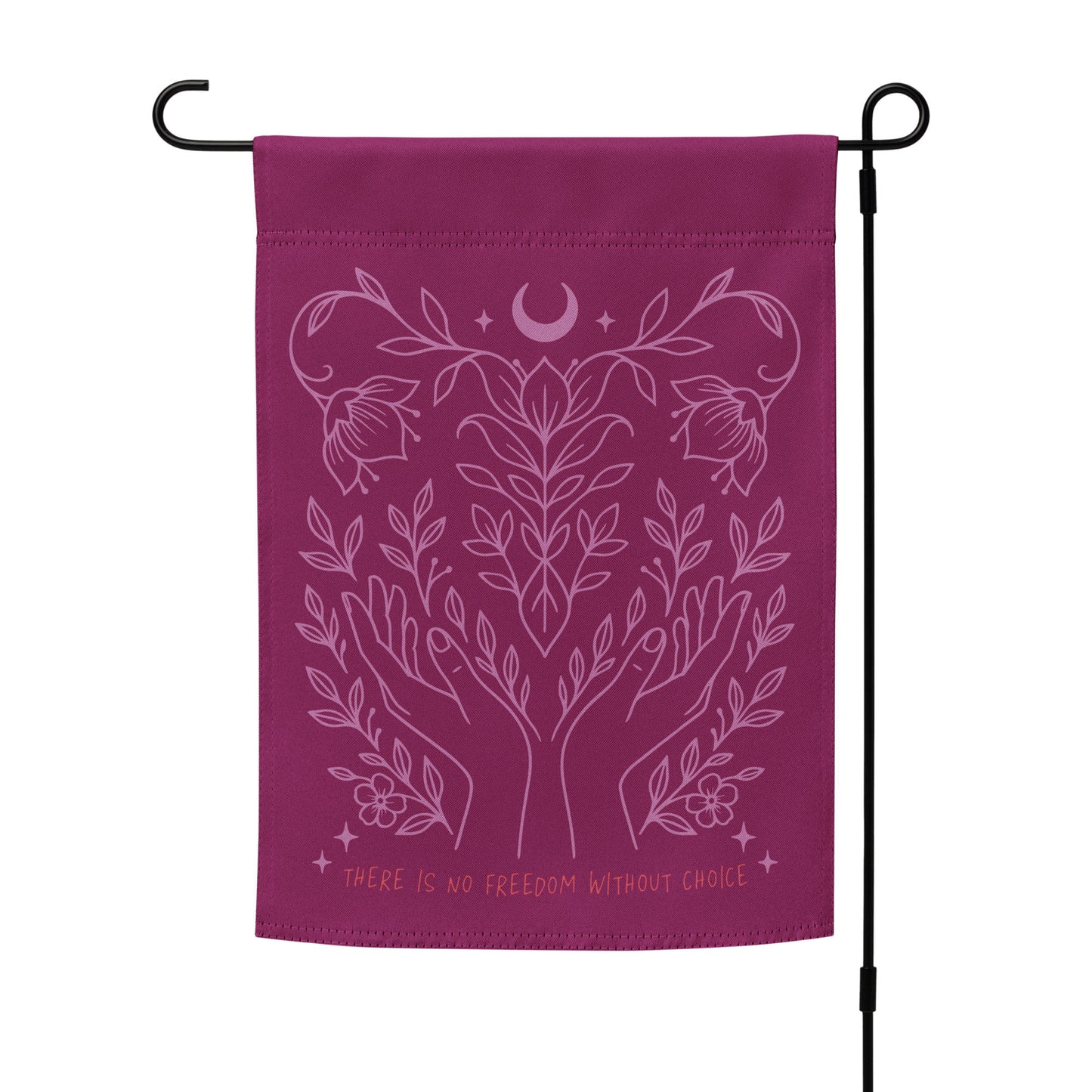 Pro-choice flag hanging on a black metal garden pole, with intricate pink illustration of vines and hands surrounding a crescent moon. Empowering outdoor statement piece by Blue Wave USA.
