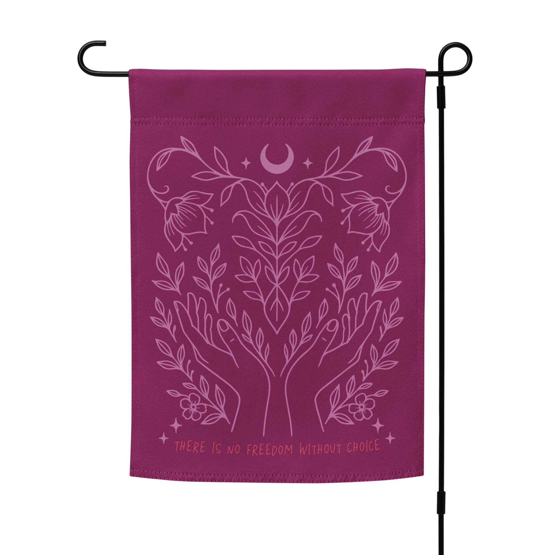 Pro-choice flag hanging on a black metal garden pole, with intricate pink illustration of vines and hands surrounding a crescent moon. Empowering outdoor statement piece by Blue Wave USA.