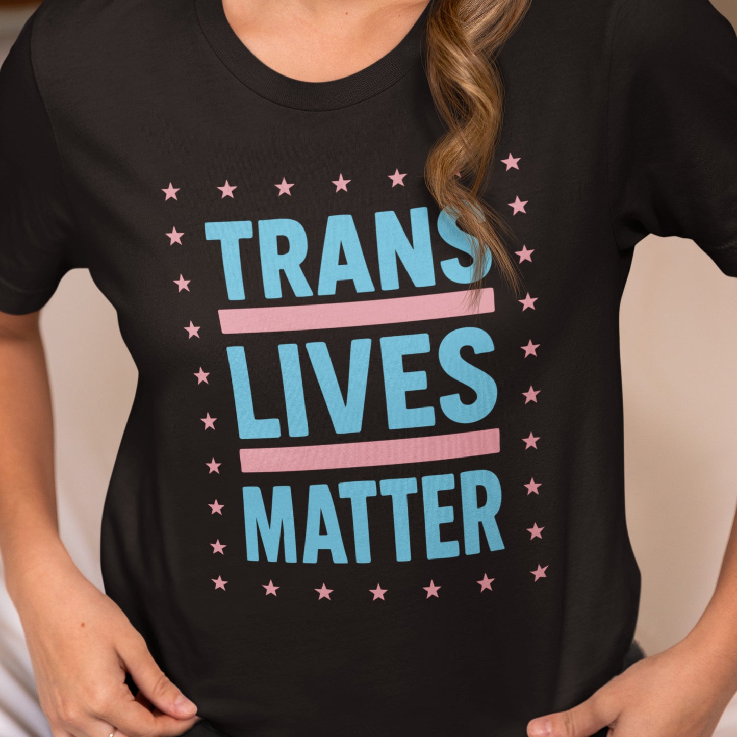 Model wearing activist T-shirt featuring trans pride colors and the phrase “Trans Lives Matter” representing transgender visibility, equality, and progressive apparel.