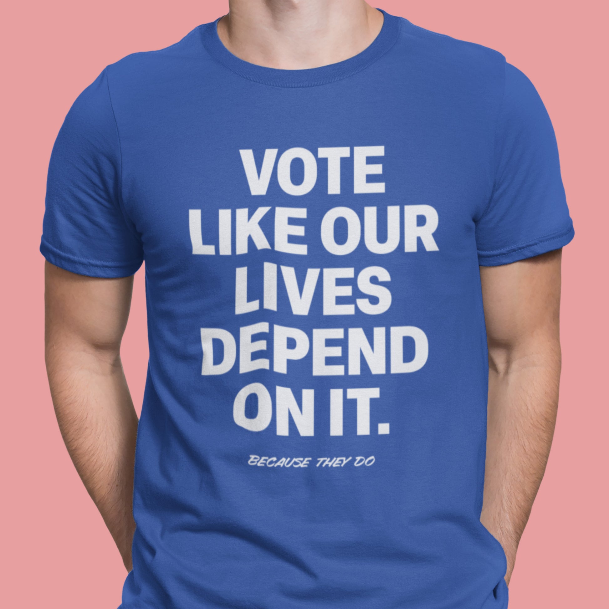 Person wearing a royal blue Vote Like Our Lives Depend On It t-shirt. The strong white lettering stands out as a statement of urgency, solidarity, and shared responsibility.