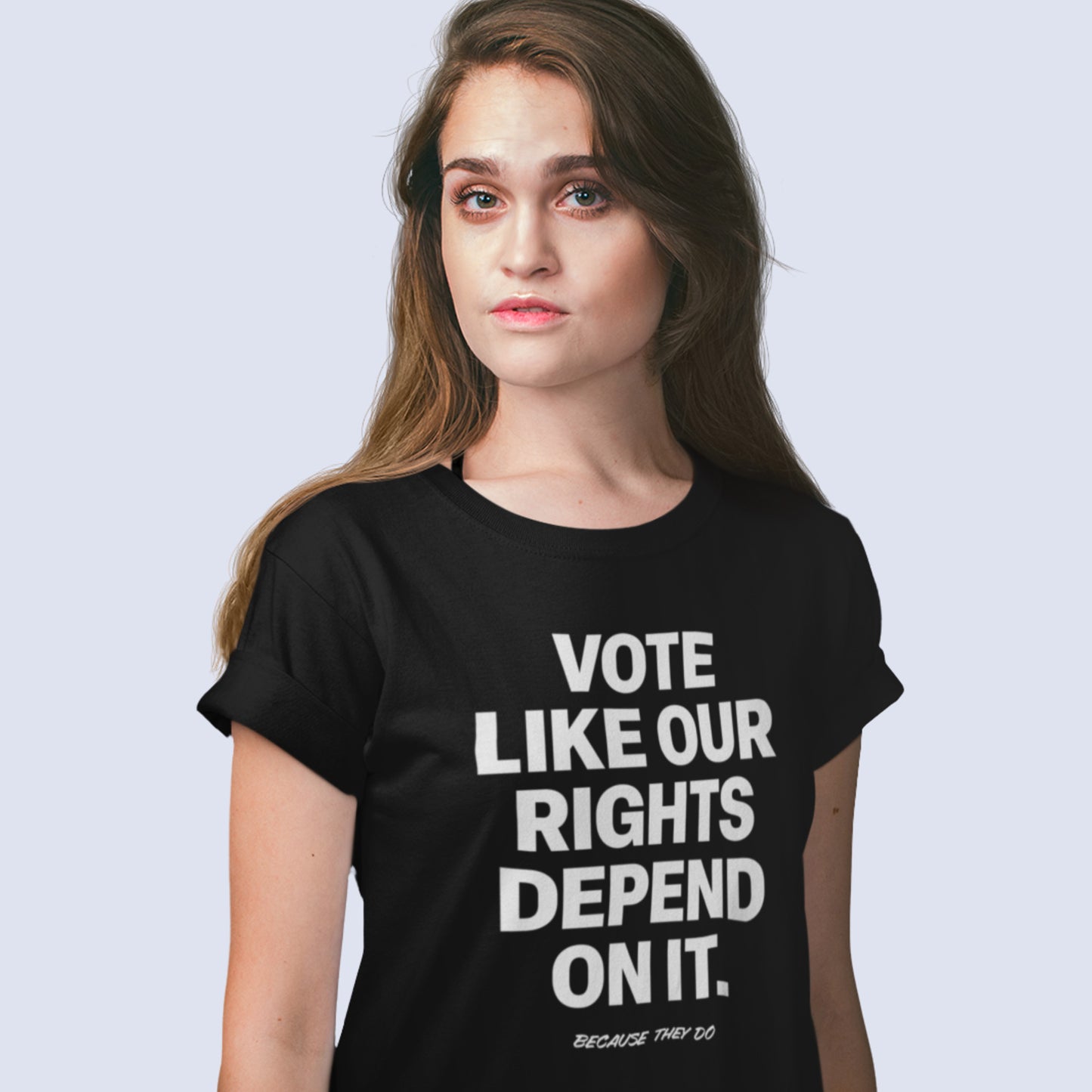 Person wearing a black Vote Like Our Rights Depend On It tee with clean white text. The bold design captures the urgency of protecting democracy — a signature message from Blue Wave USA.