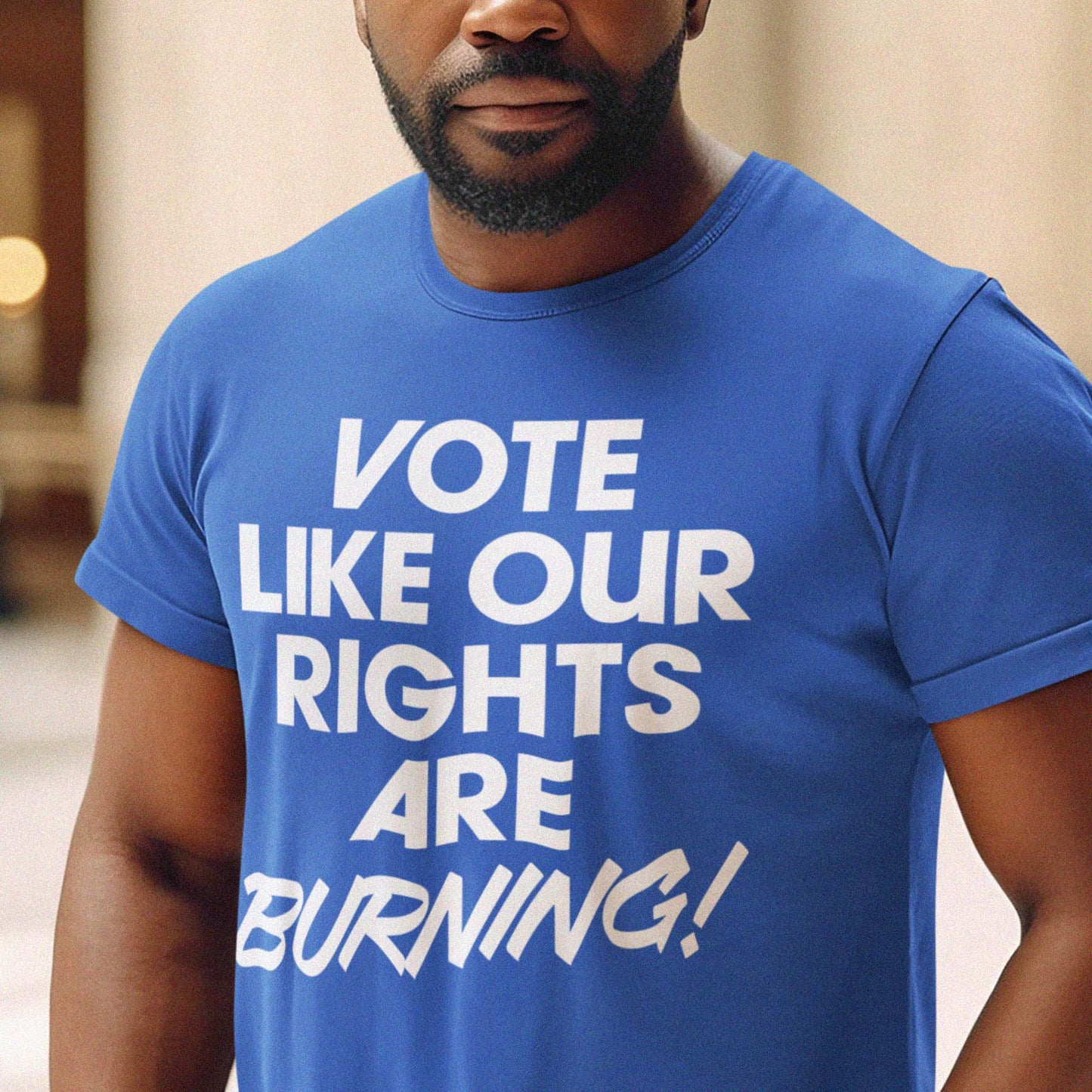 Person wearing a royal blue Vote Like Our Rights Are Burning! t-shirt. The bold typography stands out against the solid color, symbolizing urgency, progress, and civic power.