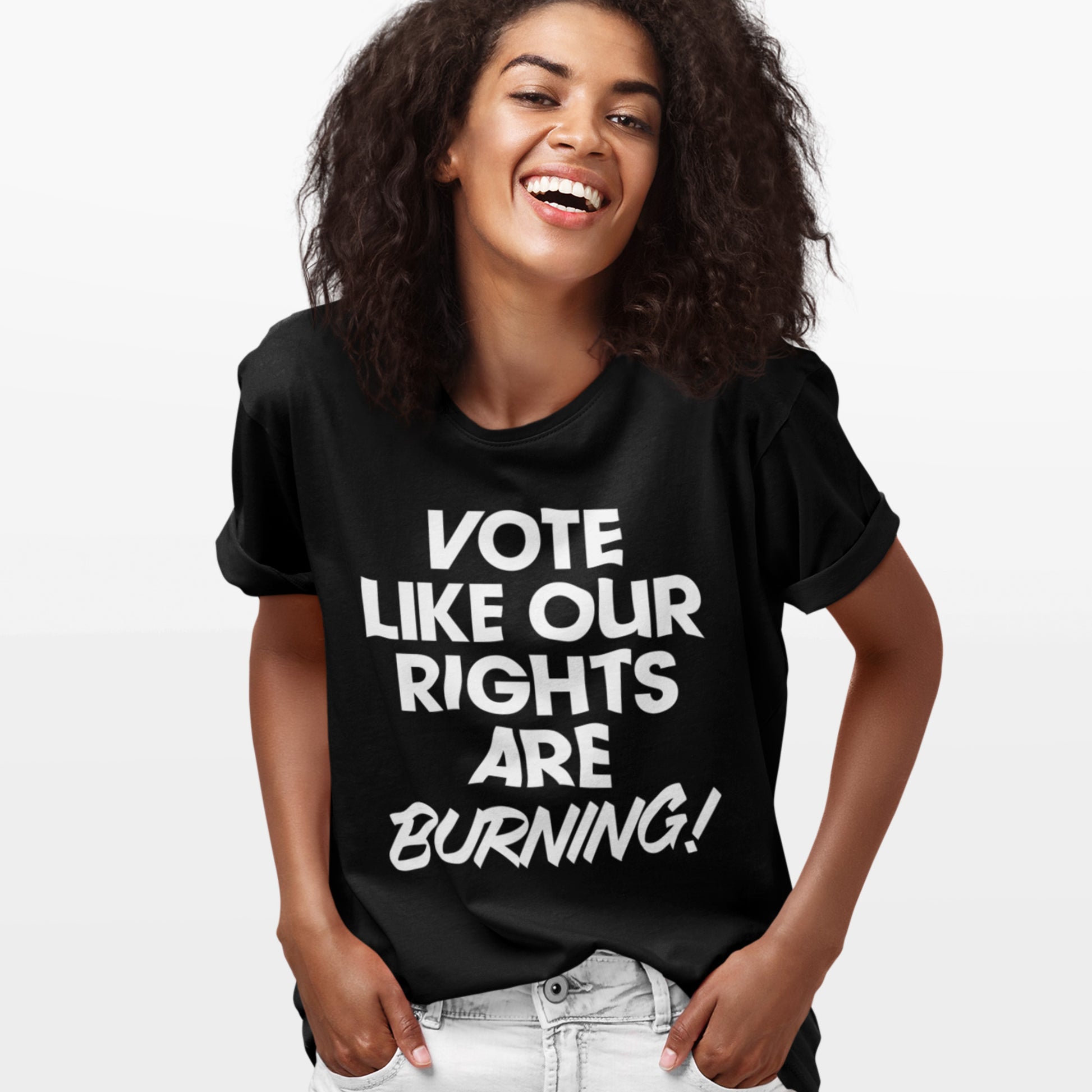 Person laughing and wearing a black Vote Like Our Rights Are Burning! t-shirt. The bright, confident lettering captures the energy of the 2025 election season — a rallying cry from Blue Wave USA.