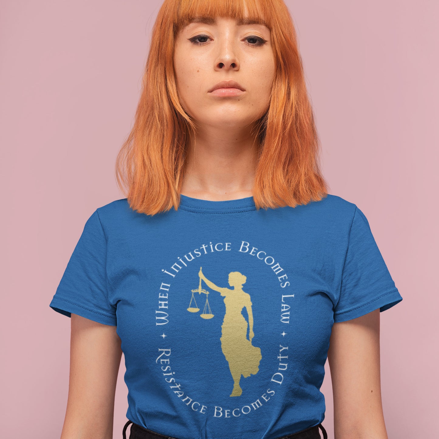 Model wearing royal blue unisex t-shirt featuring Lady Justice silhouette and circular quote design in gold, centered layout, social justice apparel from Blue Wave USA.