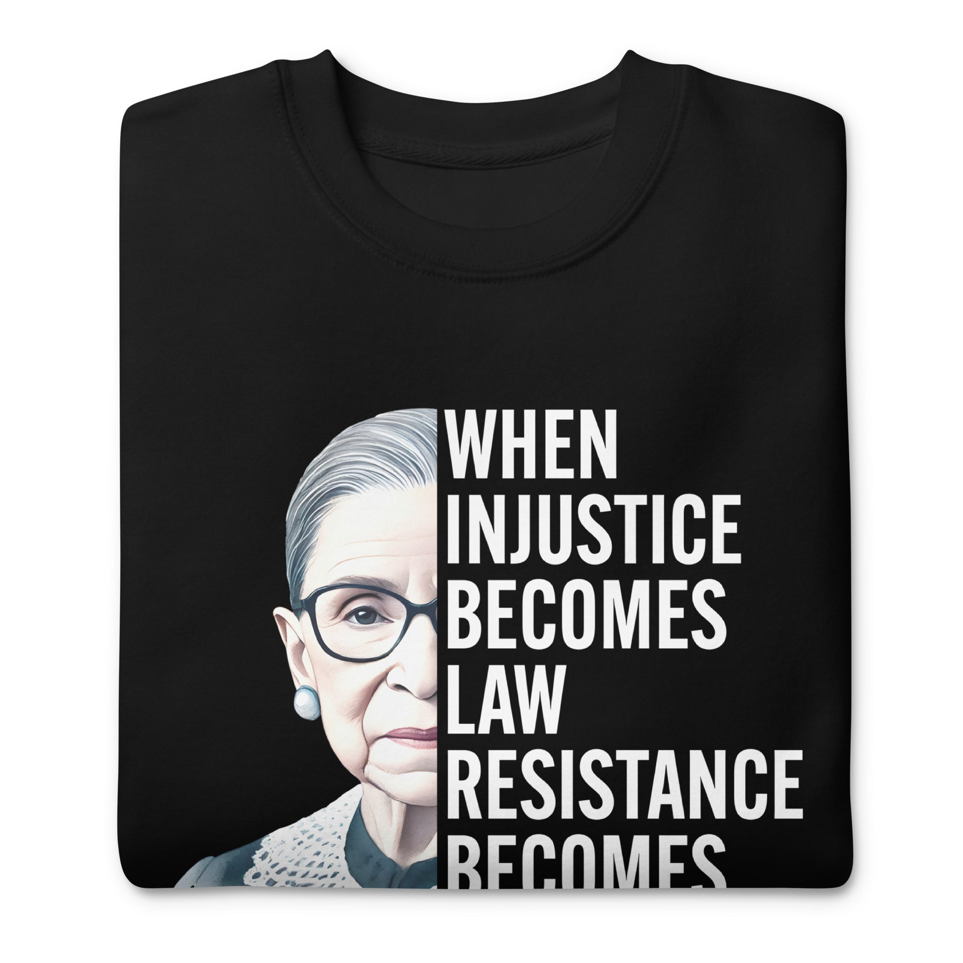 Folded black unisex premium sweatshirt featuring Ruth Bader Ginsburg portrait graphic with centered progressive typography.