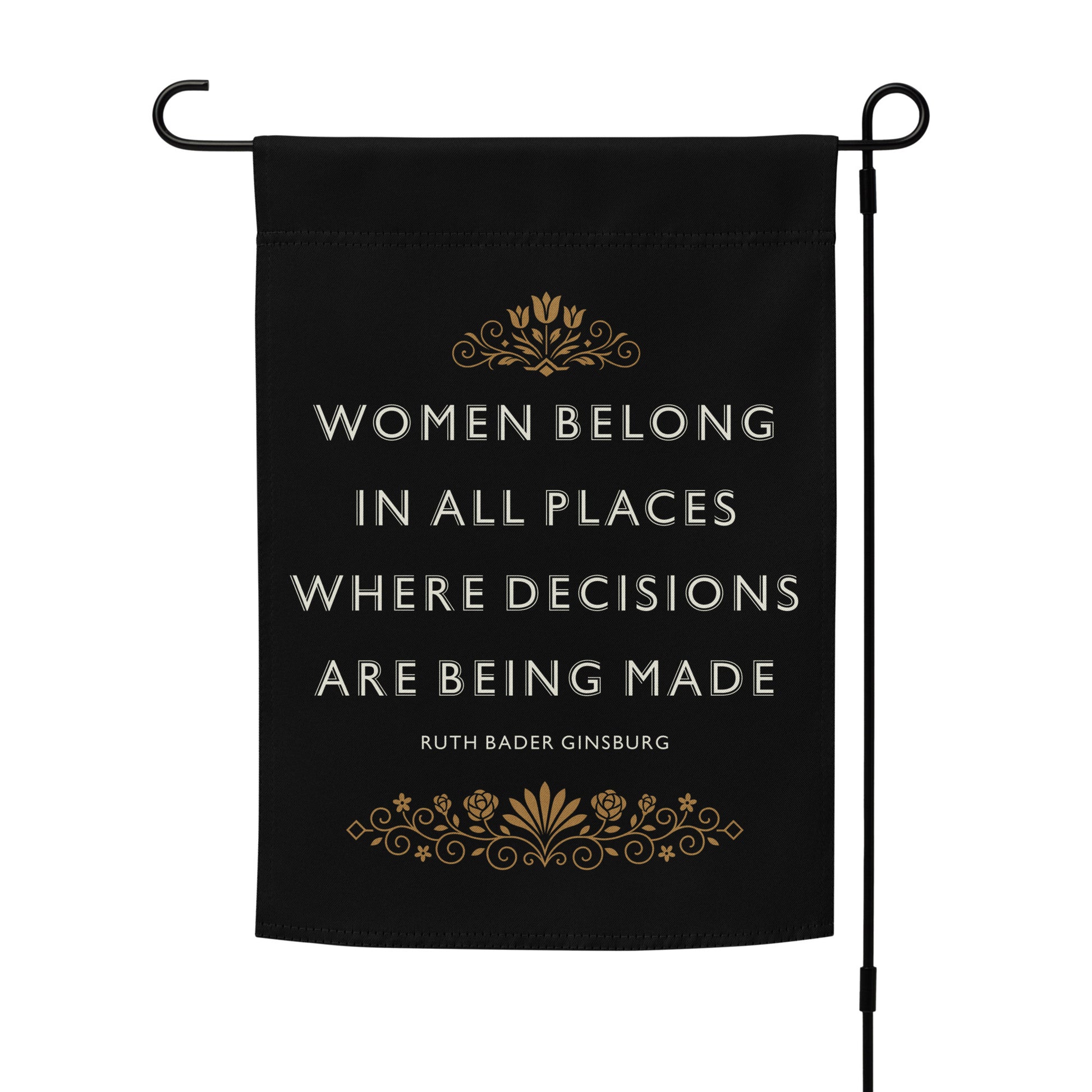 “Women Belong In All Places Where Decisions Are Being Made” progressive garden flag on a flag stand, featuring bold lettering and ornate gold decoration.